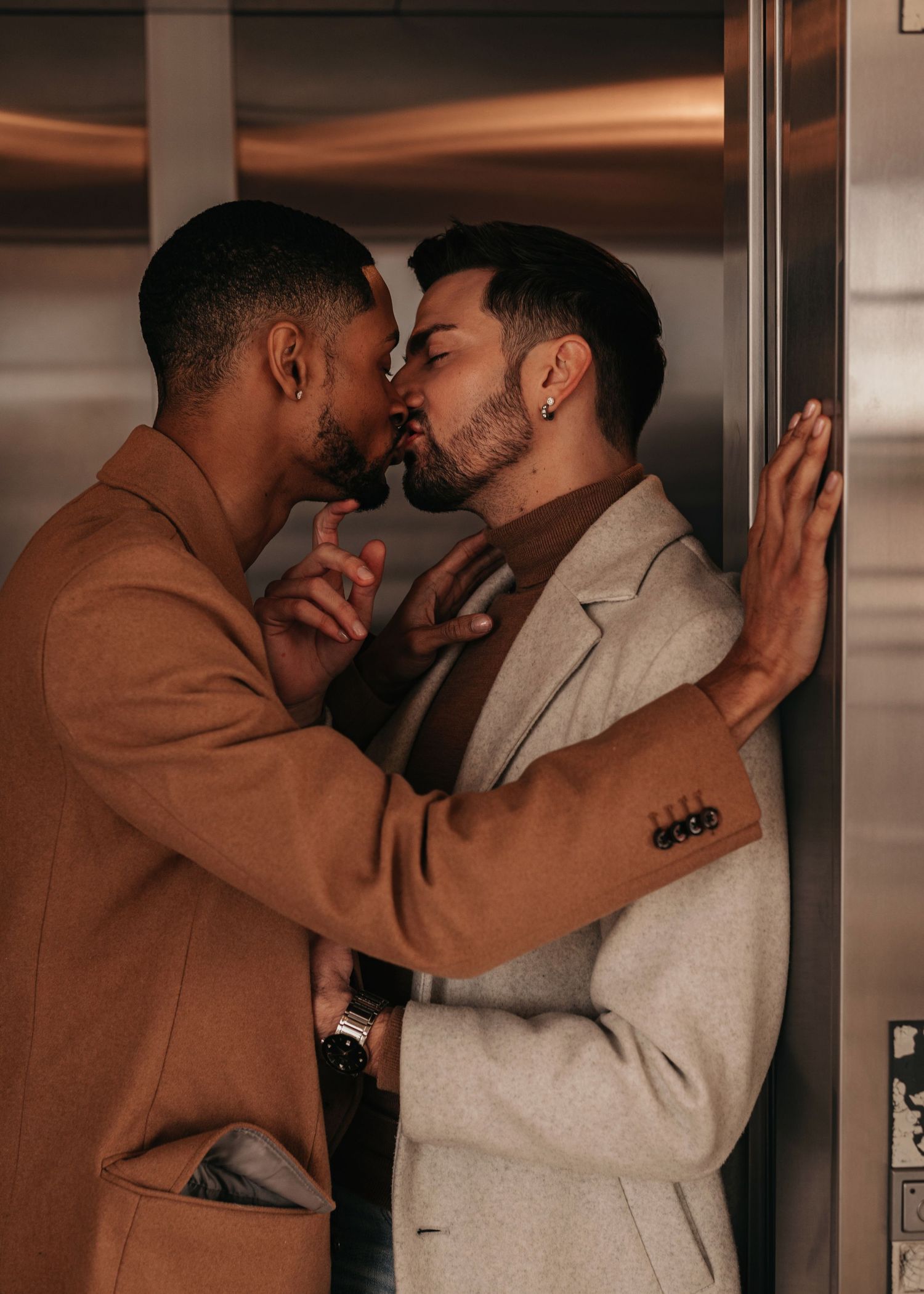 Intimate elevator LGTBQ engagement portrait with modern editorial style, photographed by Catch Your Fire Photography at Bridge Street