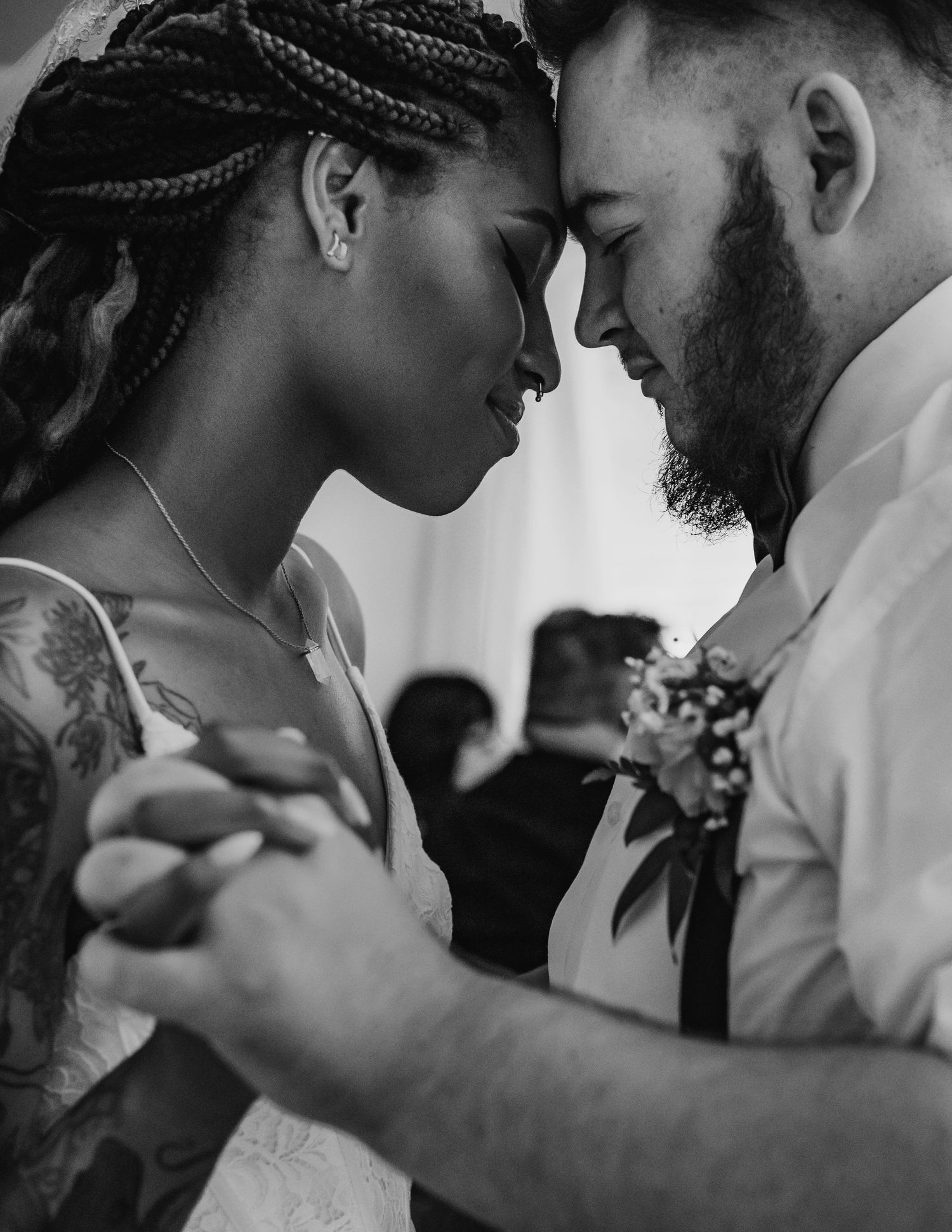 Black and white close-up of interracial couple touching foreheads during first dance at The Wedding Chapel on the Mountain