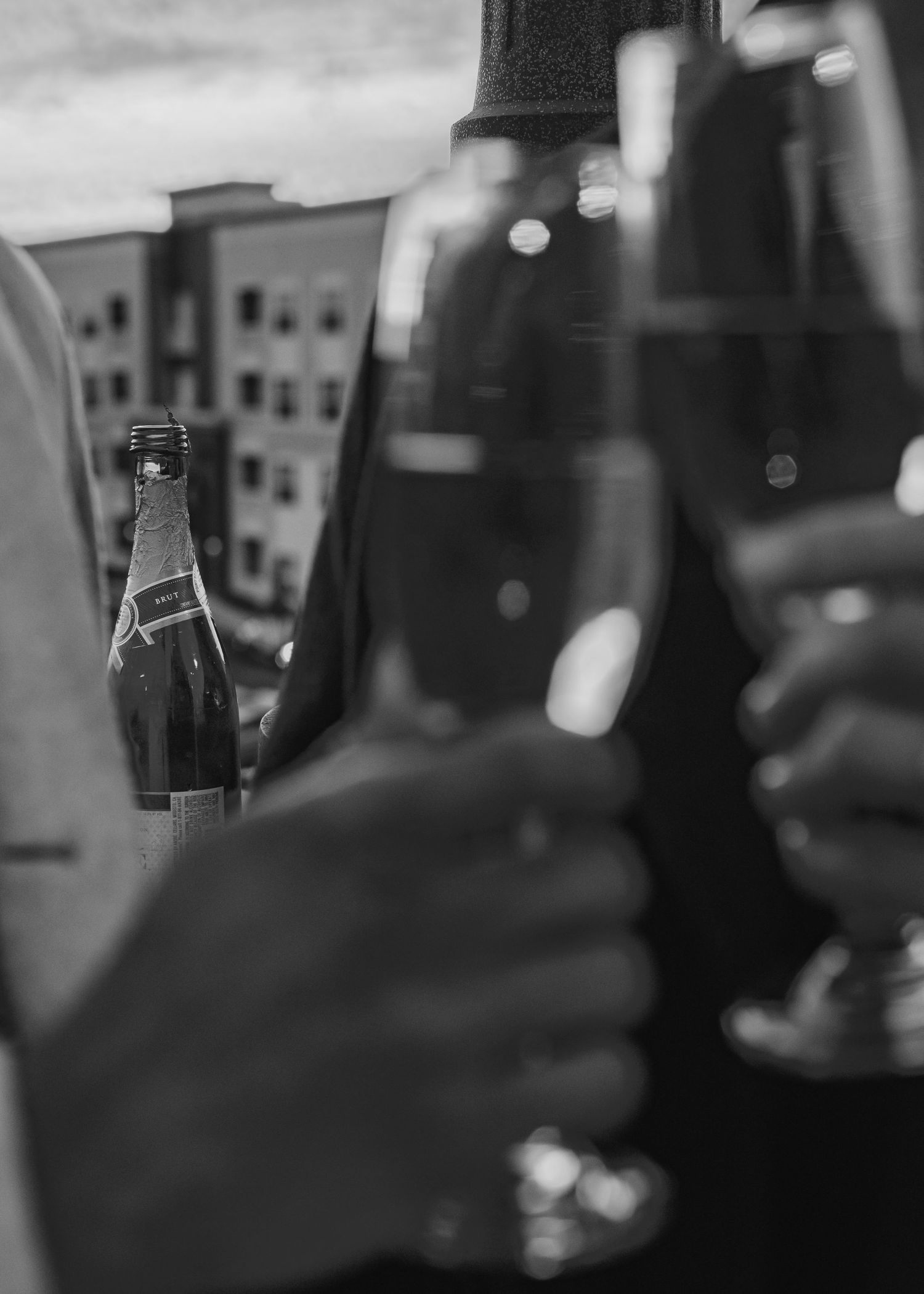Close-up black and white champagne toast, engagement detail by Catch Your Fire Photography at Bridge Street in Huntsville
