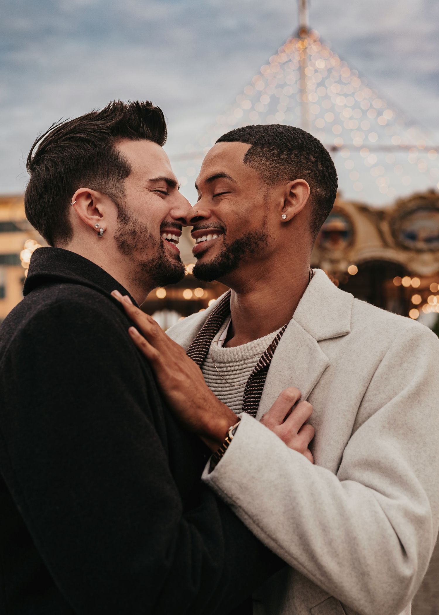 Romantic LGBTQ proposal in front of carousel, captured by Catch Your Fire Photography in Huntsville, AL at Bridge Street Town Centre.
