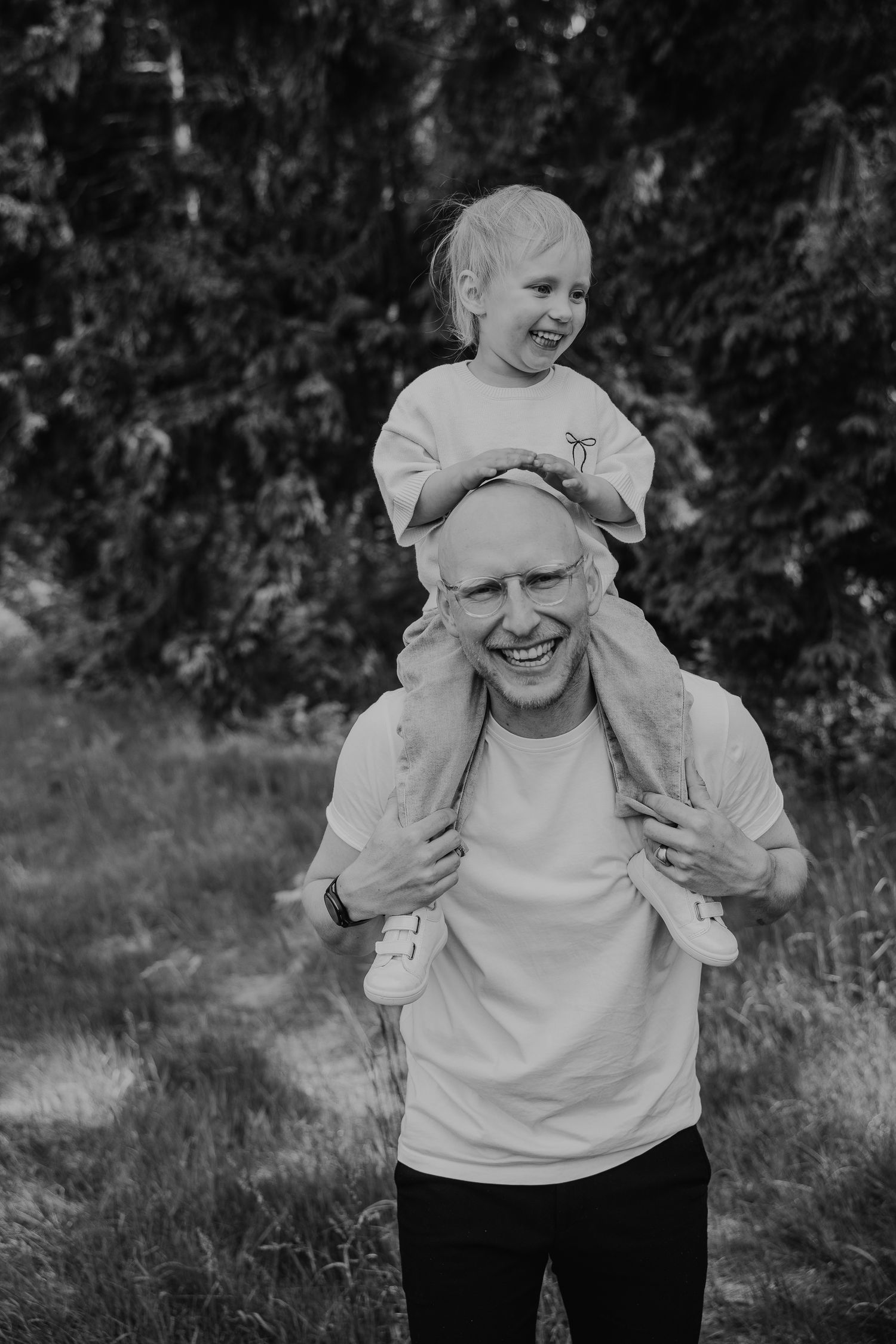 Authentischer Hochzeitsmoment mit Kind auf den Schultern in natürlicher Reportagefotografie