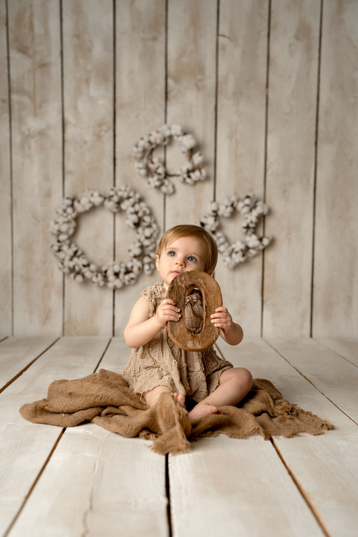 Studio photography setup with wooden backdrop and natural props.