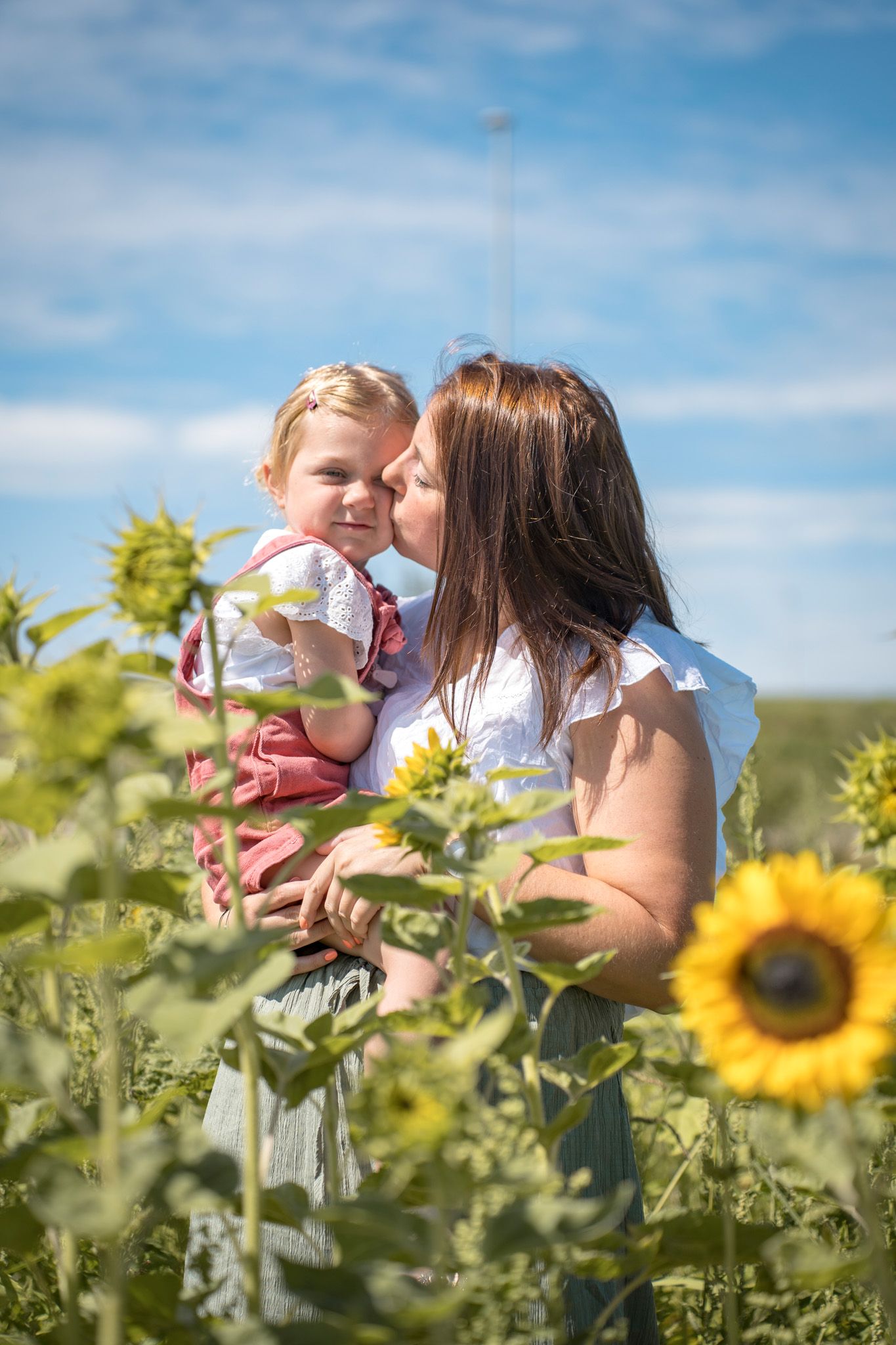 Beautiful candid moments captured in a sunflower field on a bright summer day.