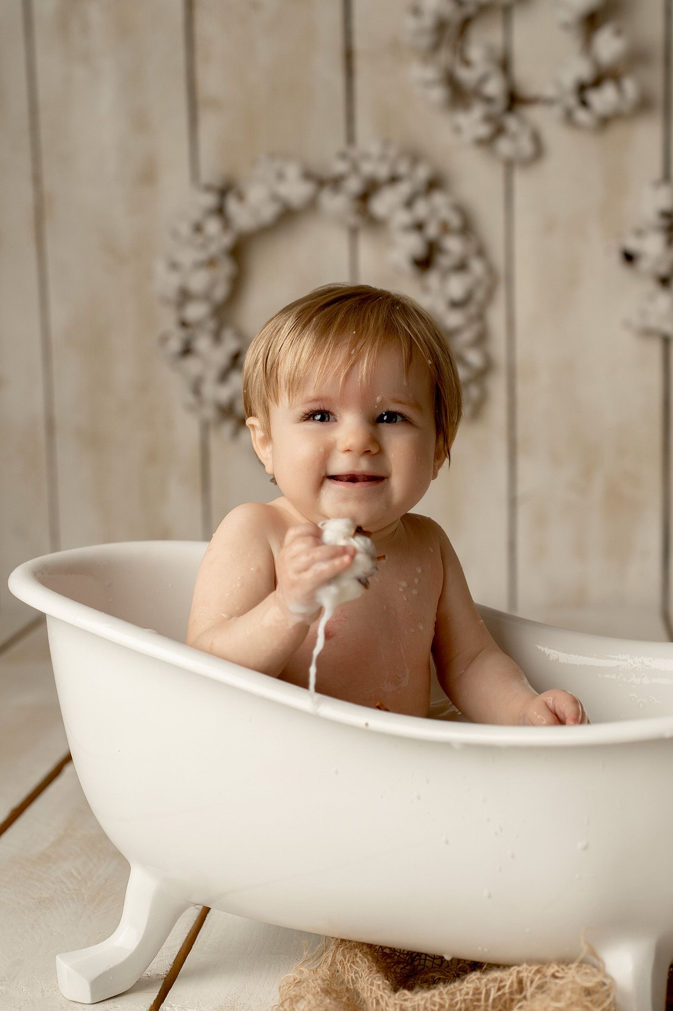 White clawfoot bathtub photo session with bubbles and splashes.