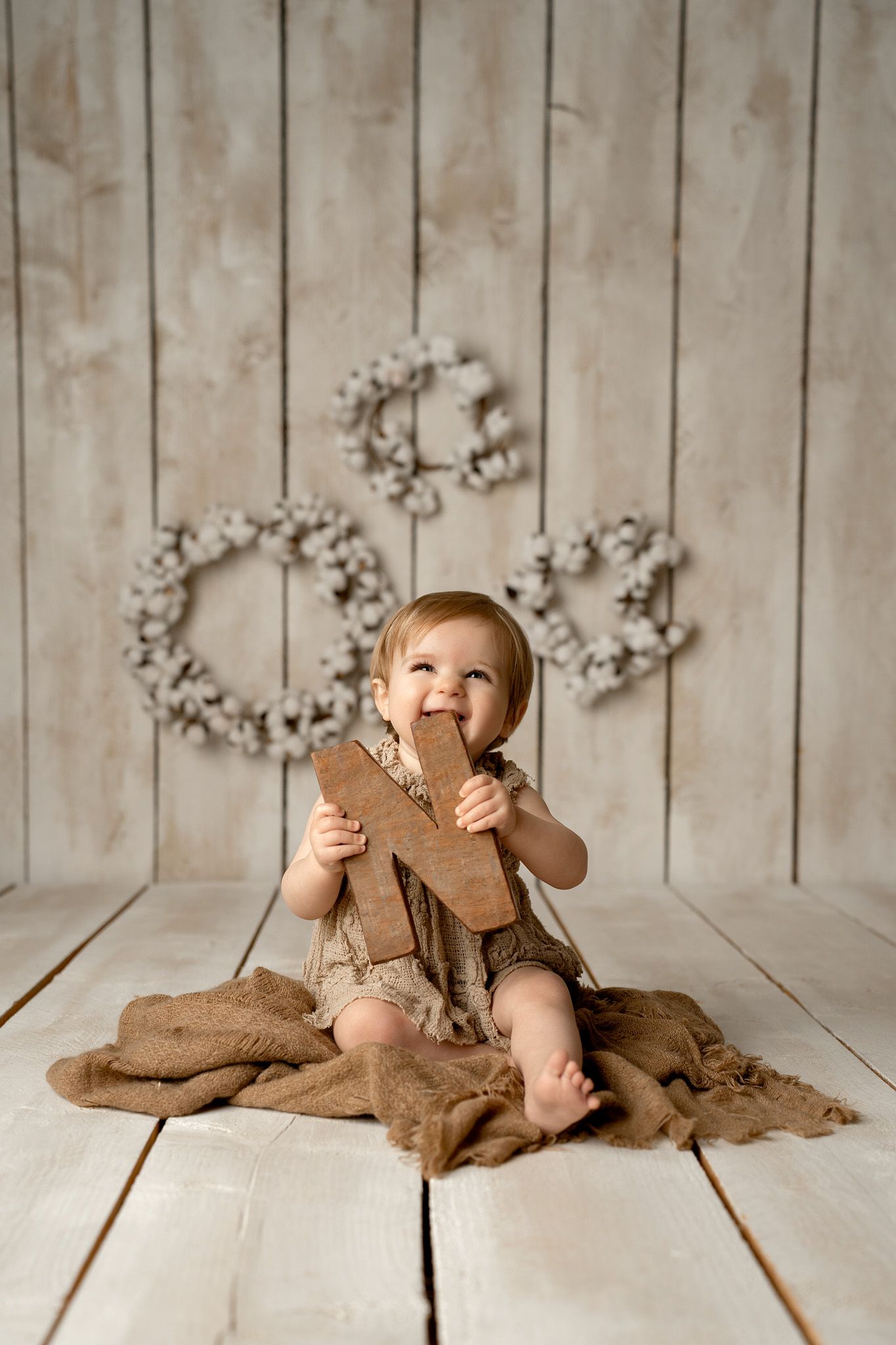 Cozy photography scene with rustic wooden background and soft lighting.