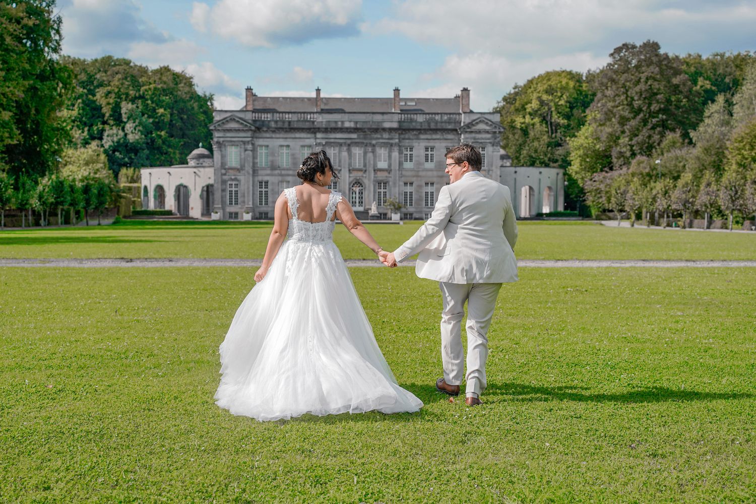Wedding couple takes romantic photos on sprawling mansion grounds.