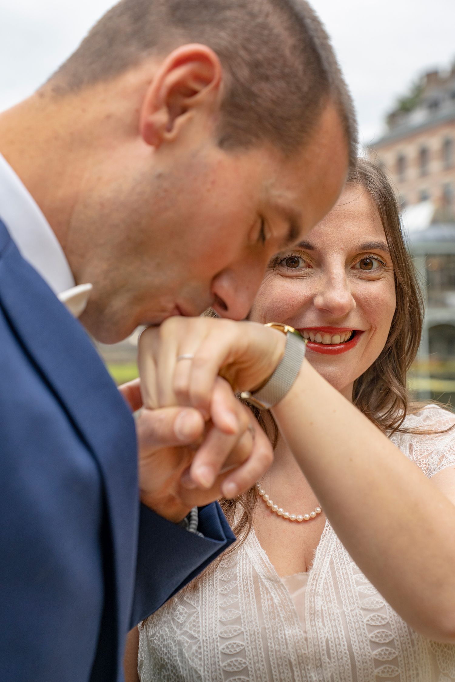 Close-up romantic moment between a couple in formal attire outdoors.