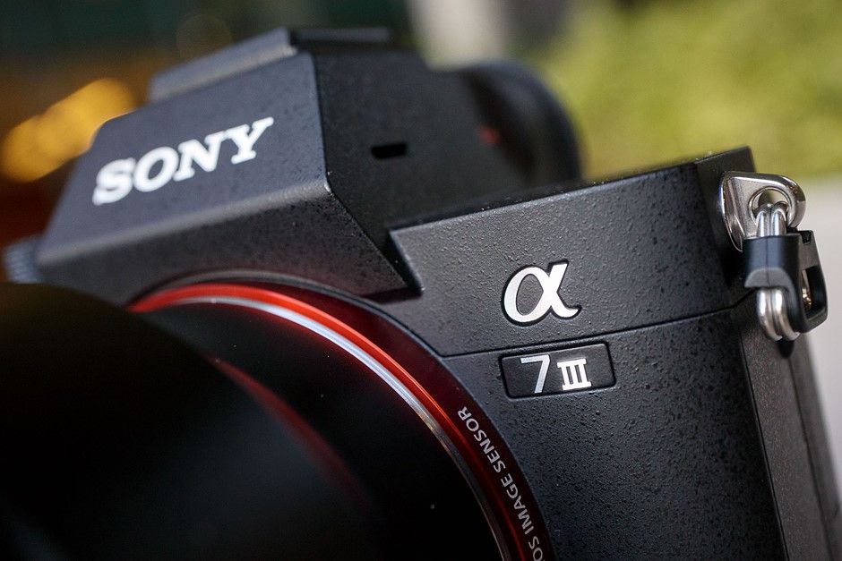Close-up detail of a Sony Alpha III mirrorless camera showing the brand name and model designation in black.
