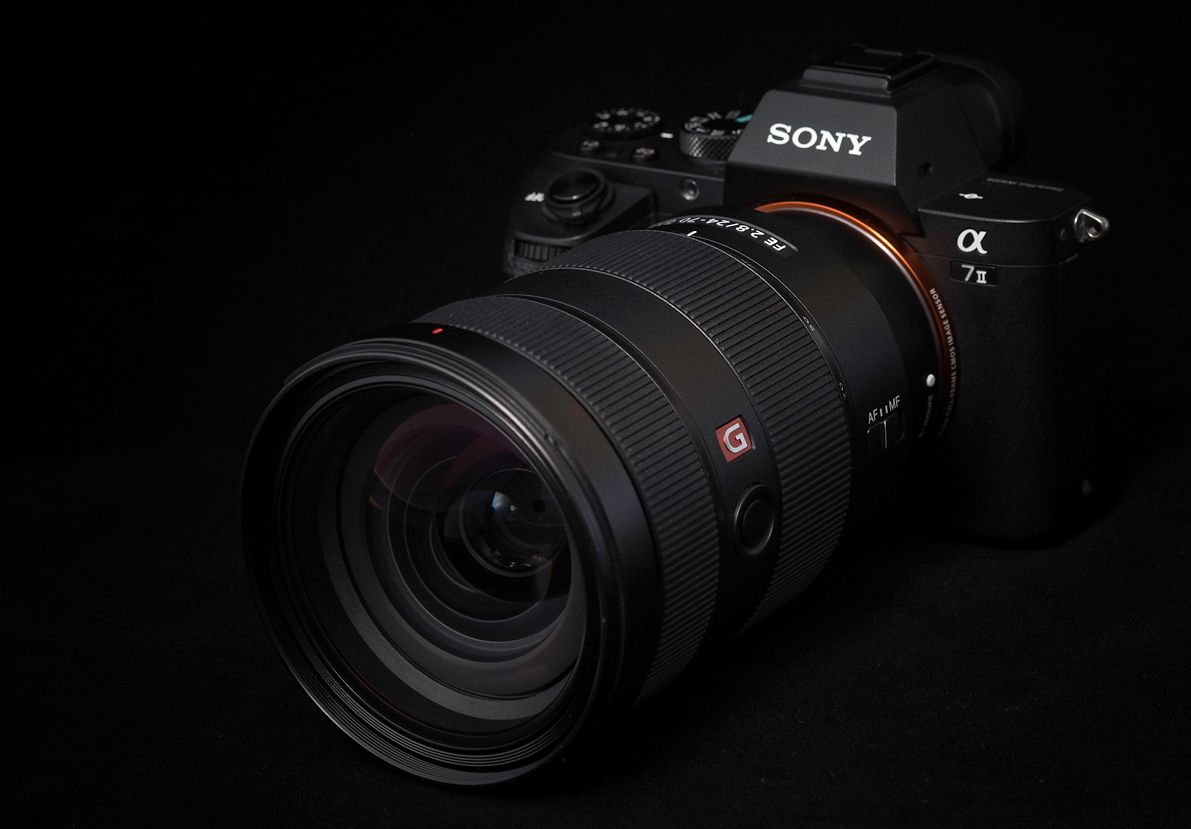 A Sony Alpha mirrorless camera with a large GM lens mounted on a black background.