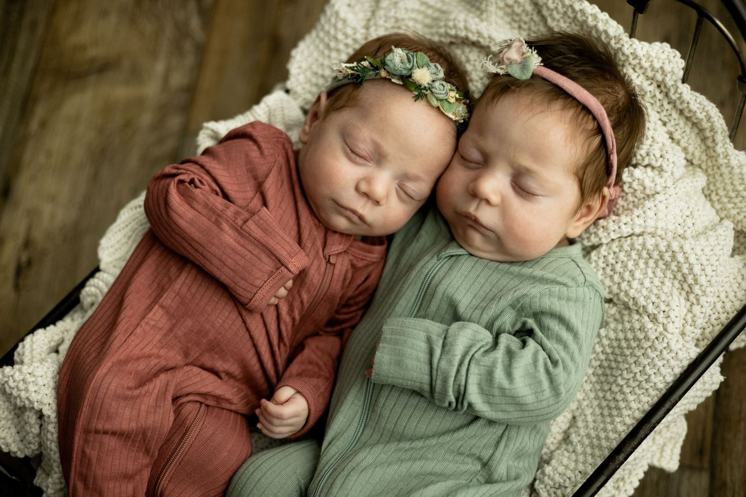 Twin baby girls laying in a bed prop in photo taken by Little Buckaroo Portrait Co., an East Texas Newborn Photographer
