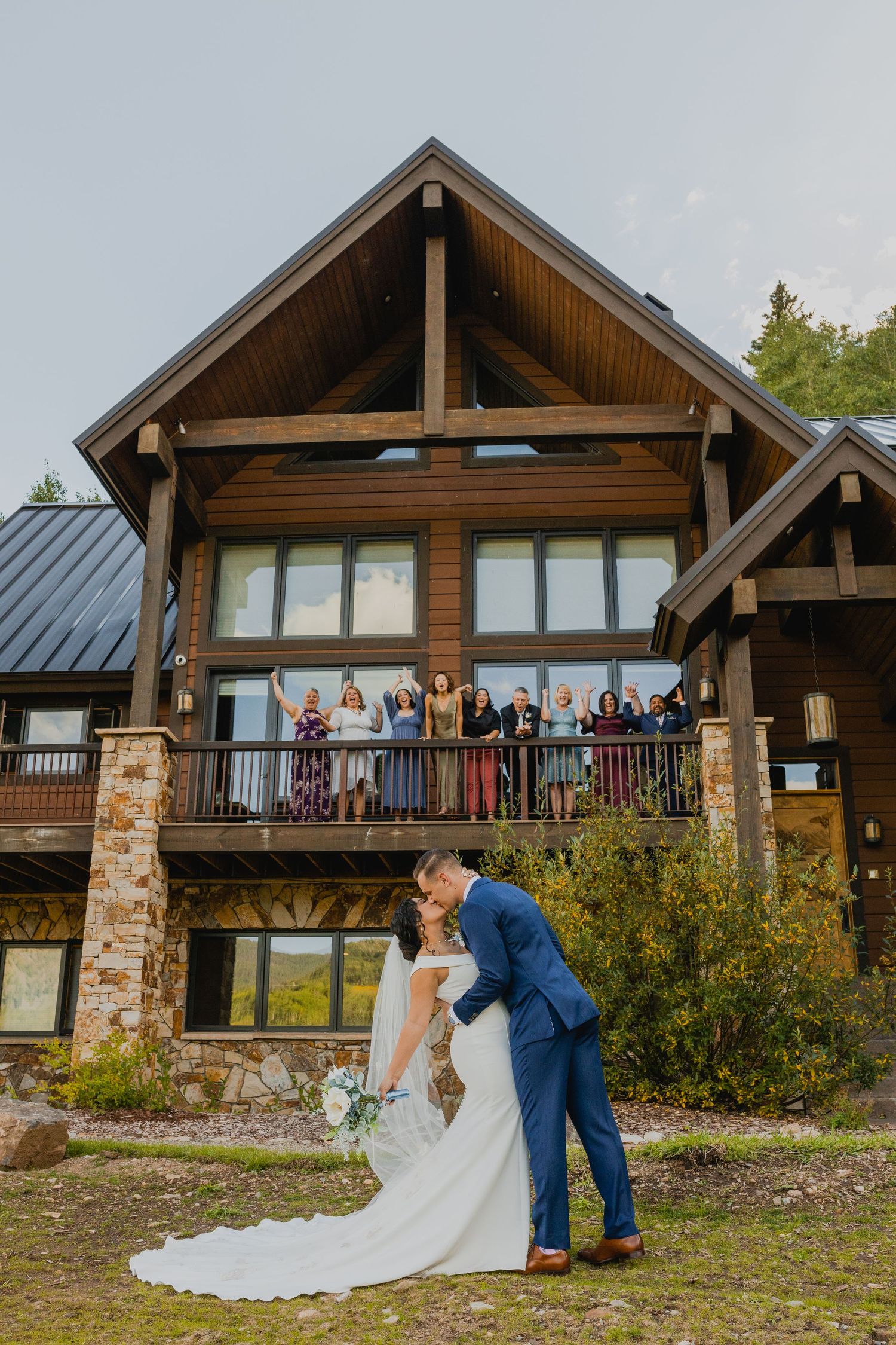 bride and groom kissing last heir wedding guests cheer them from the VRBO