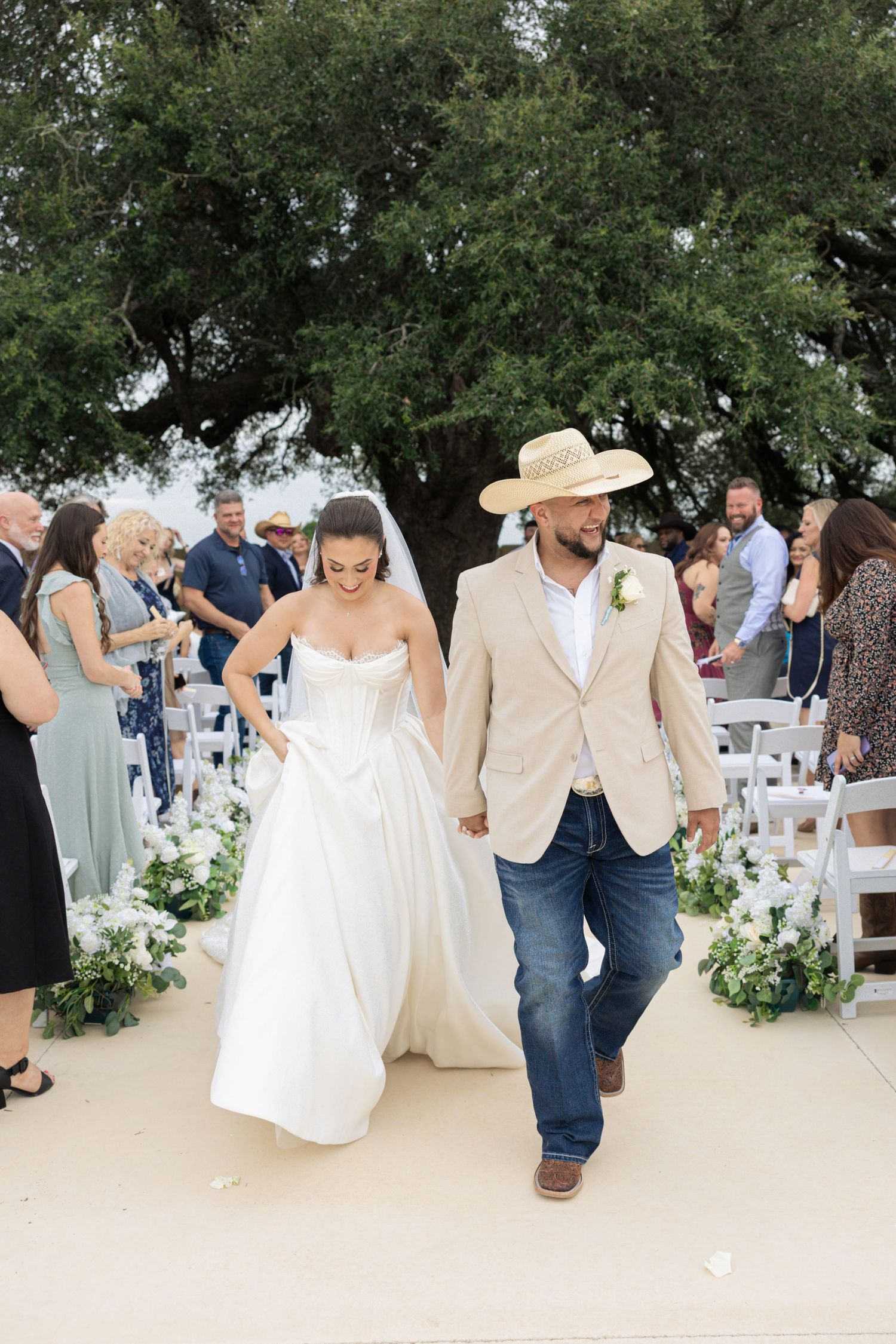 Wedding reception celebration showing dancing and movement in an outdoor venue with trees.
