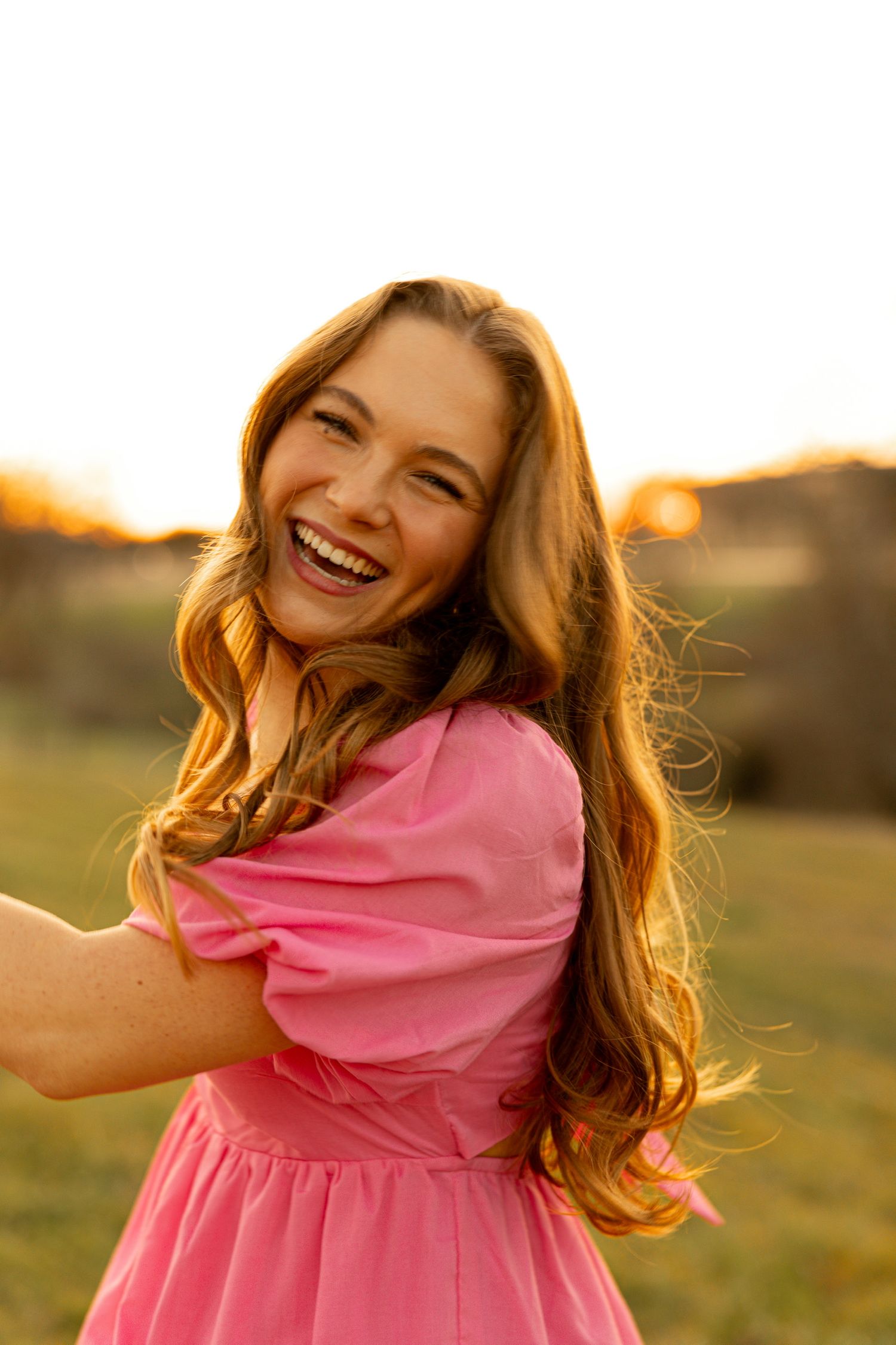 Person in pink dress twirling and laughing in sunset light across multiple frames.