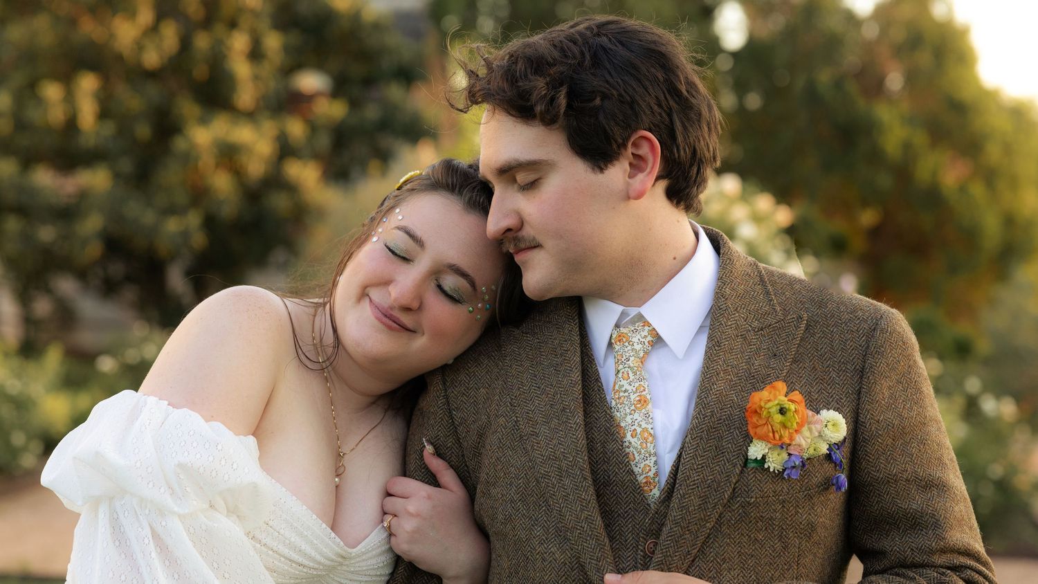 Newlyweds share intimate moments on their wedding day during golden hour.