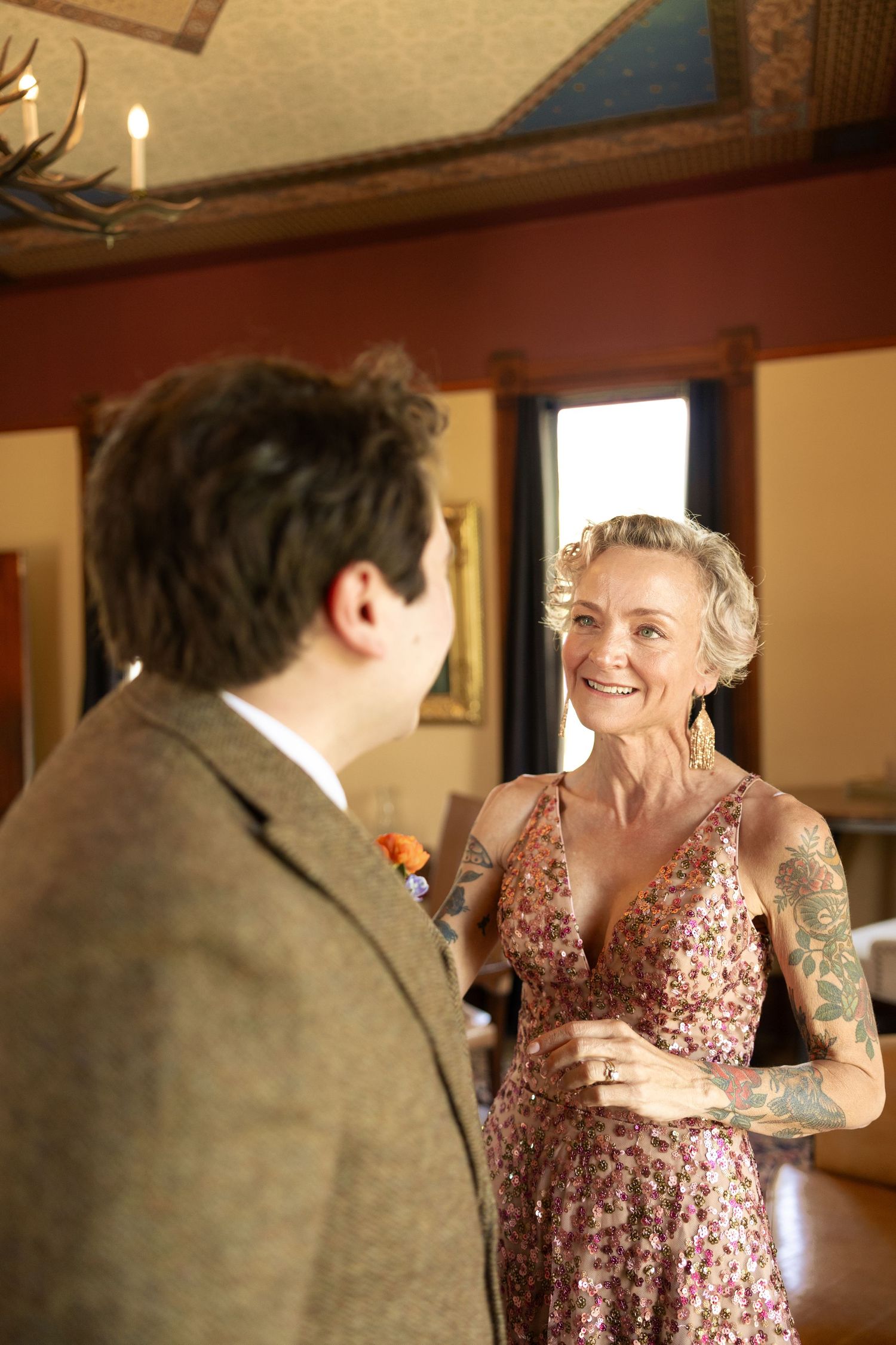 A heartwarming interaction between wedding attendees in formal attire.