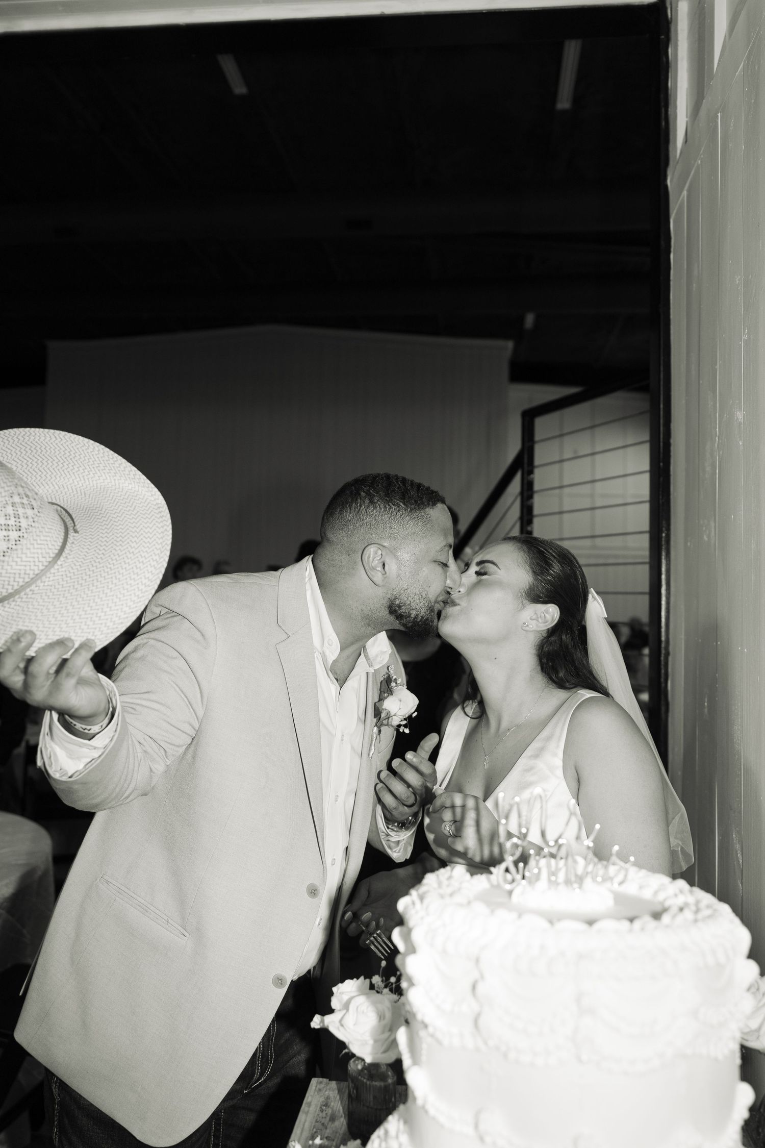 A romantic series of black and white photos showing tender moments during a wedding celebration.