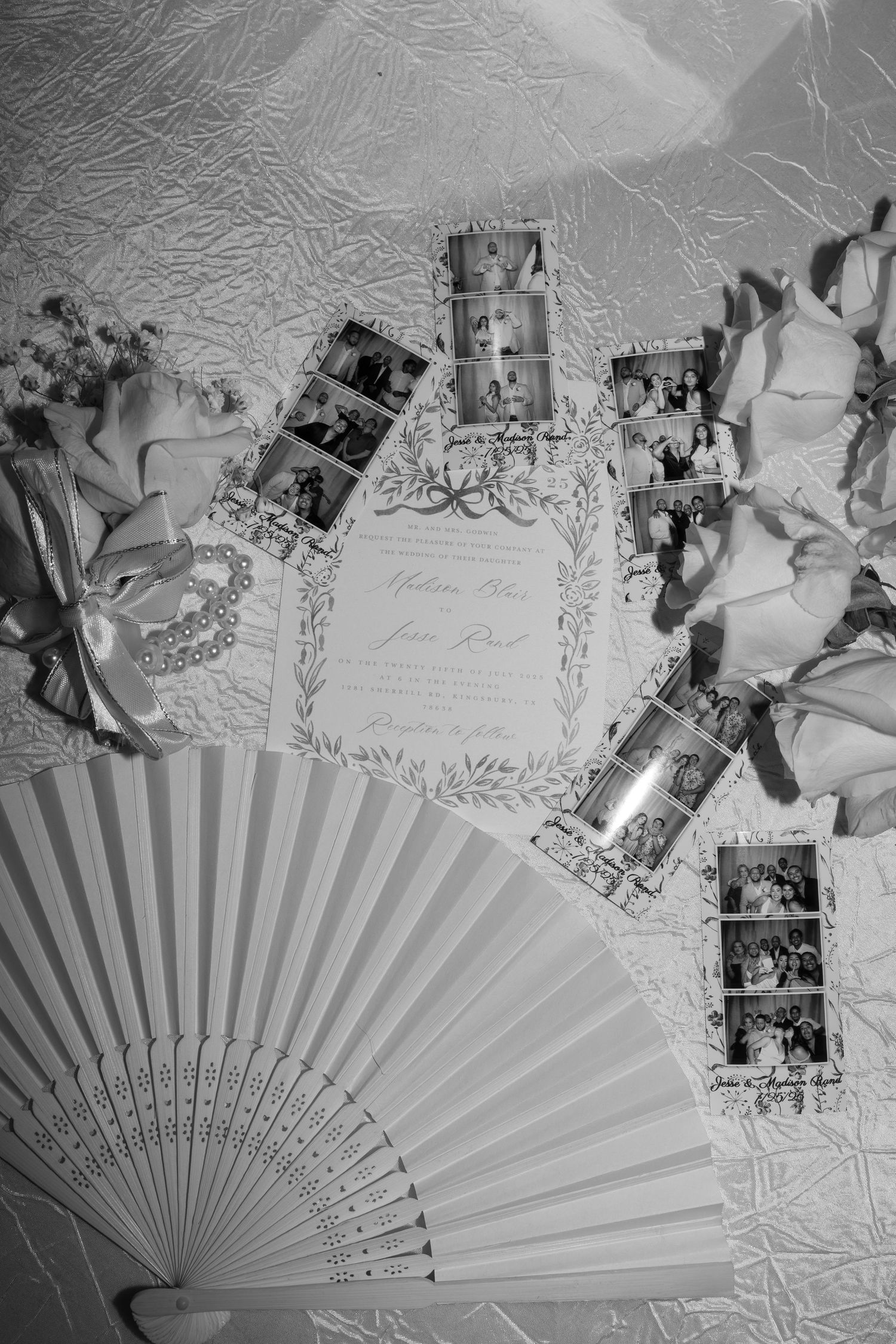 A decorative paper fan displayed with vintage photographs and floral elements in black and white.