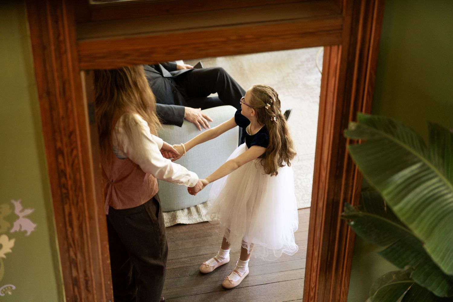 A reflection in a mirror shows wedding preparation activities.