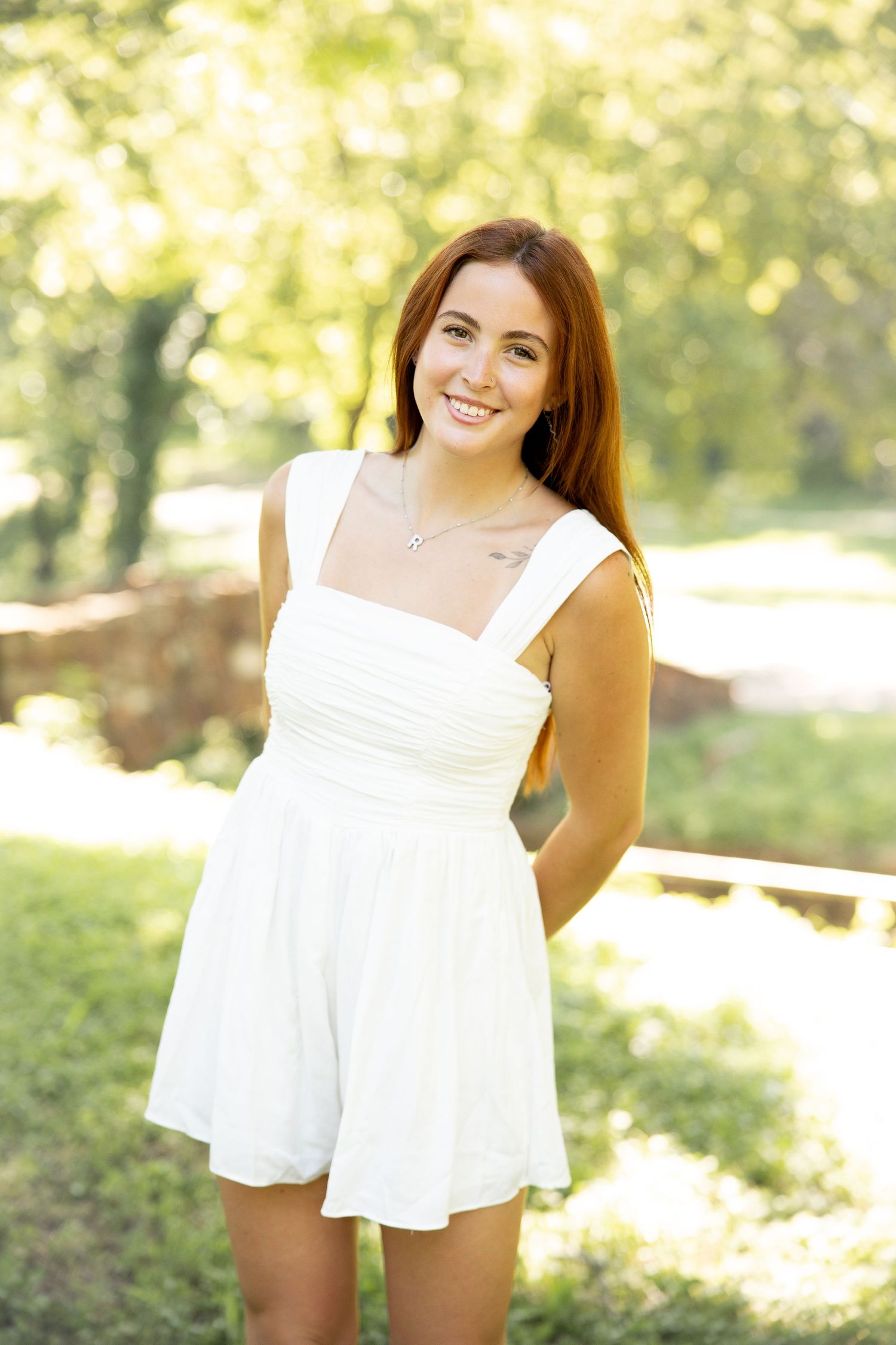White summer top portrait session in a sunny outdoor garden.