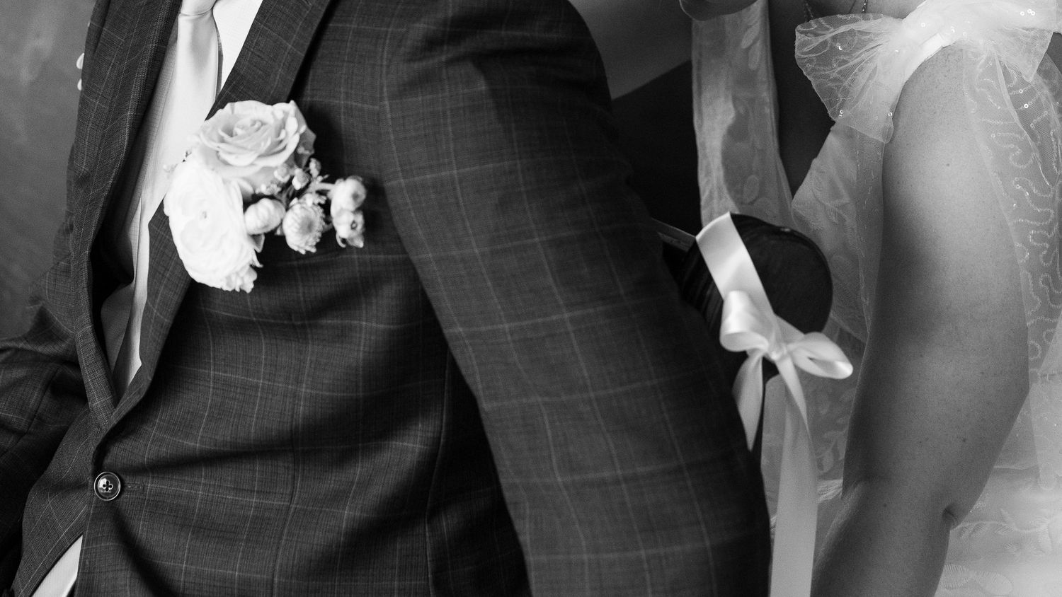 Groomsmen's formal suits and ties shown in a detailed black and white photo.