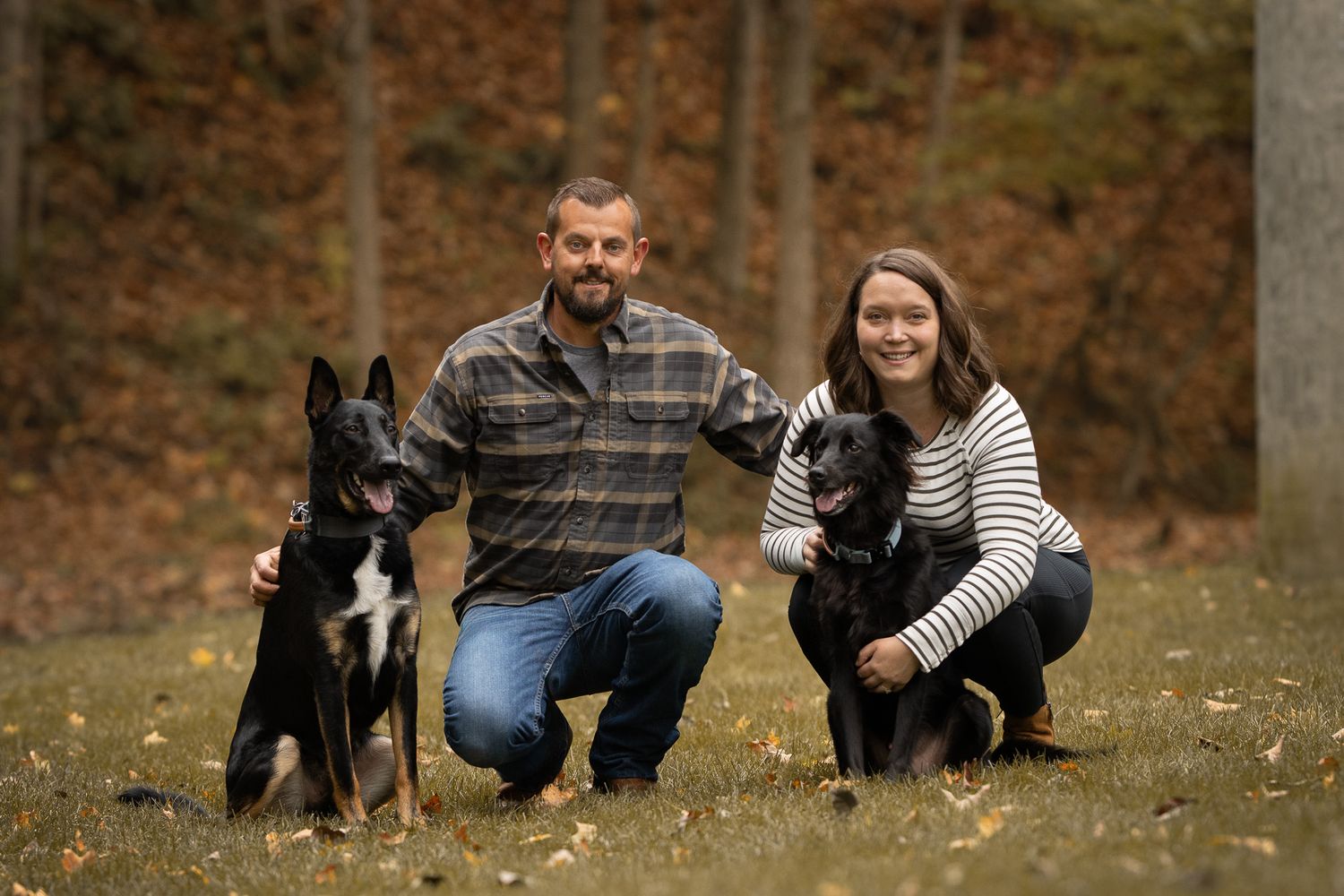 A couple sits outdoors with their dog in a series of candid autumn photos showing playful moments together.