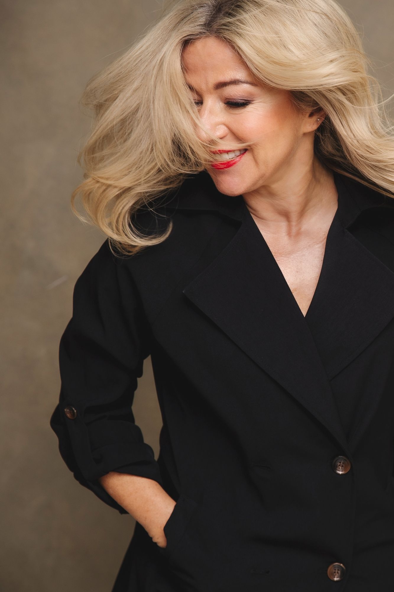 Elegant portrait series in black blazer with dramatic lighting.