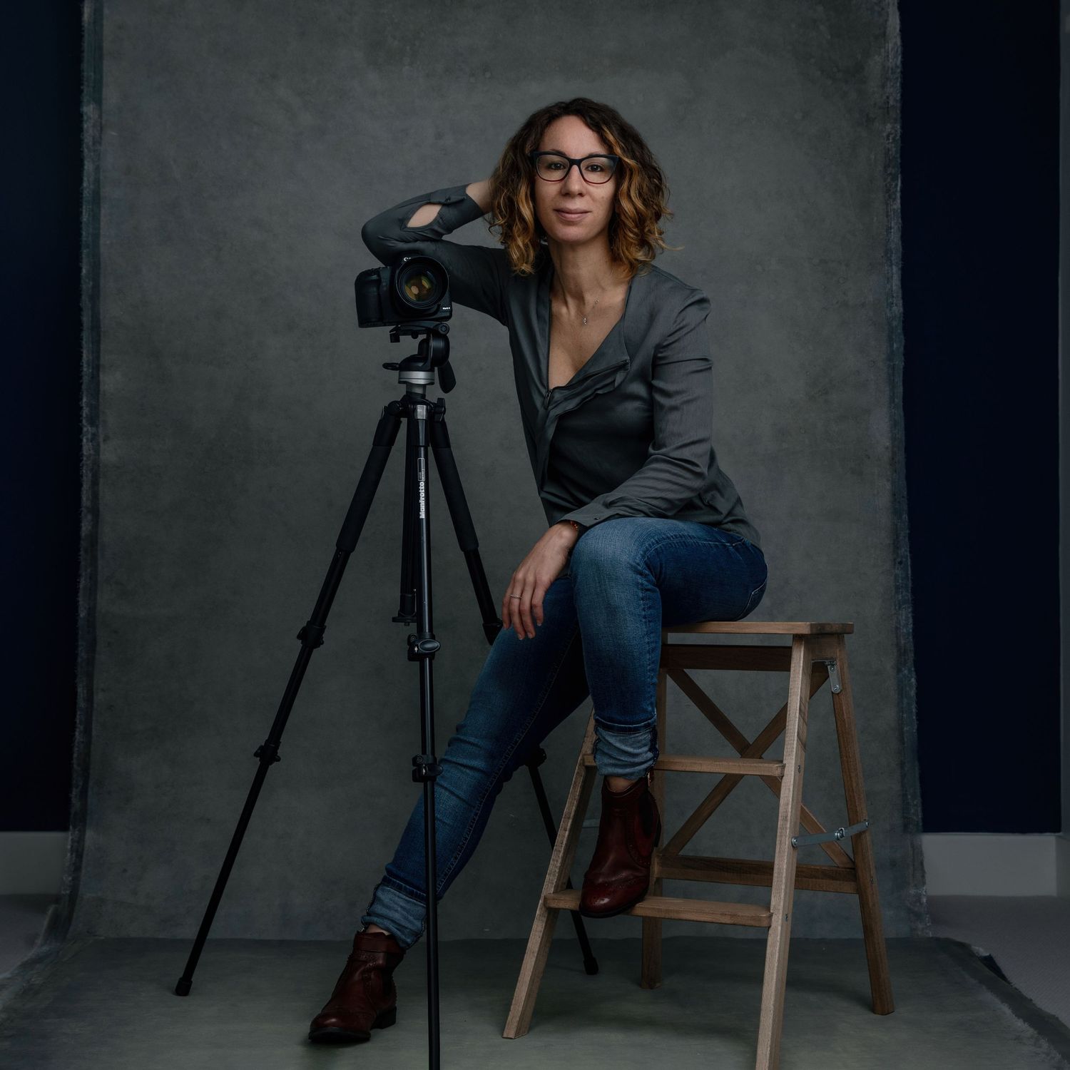 Professional photography setup with camera on tripod in studio setting.