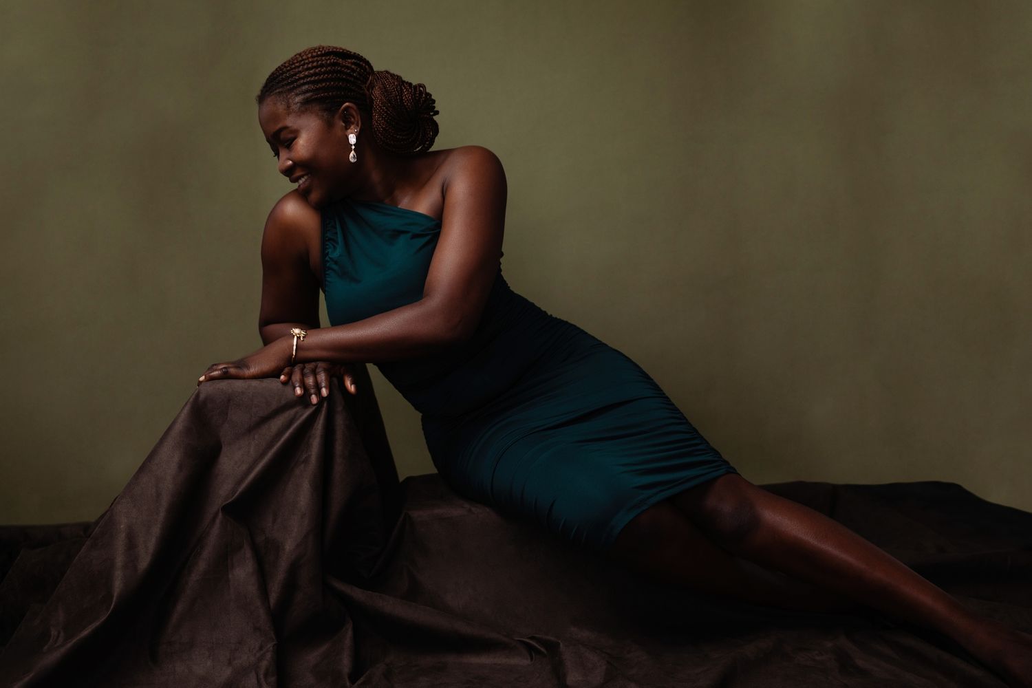 Dramatic portrait series in teal dress with moody lighting.