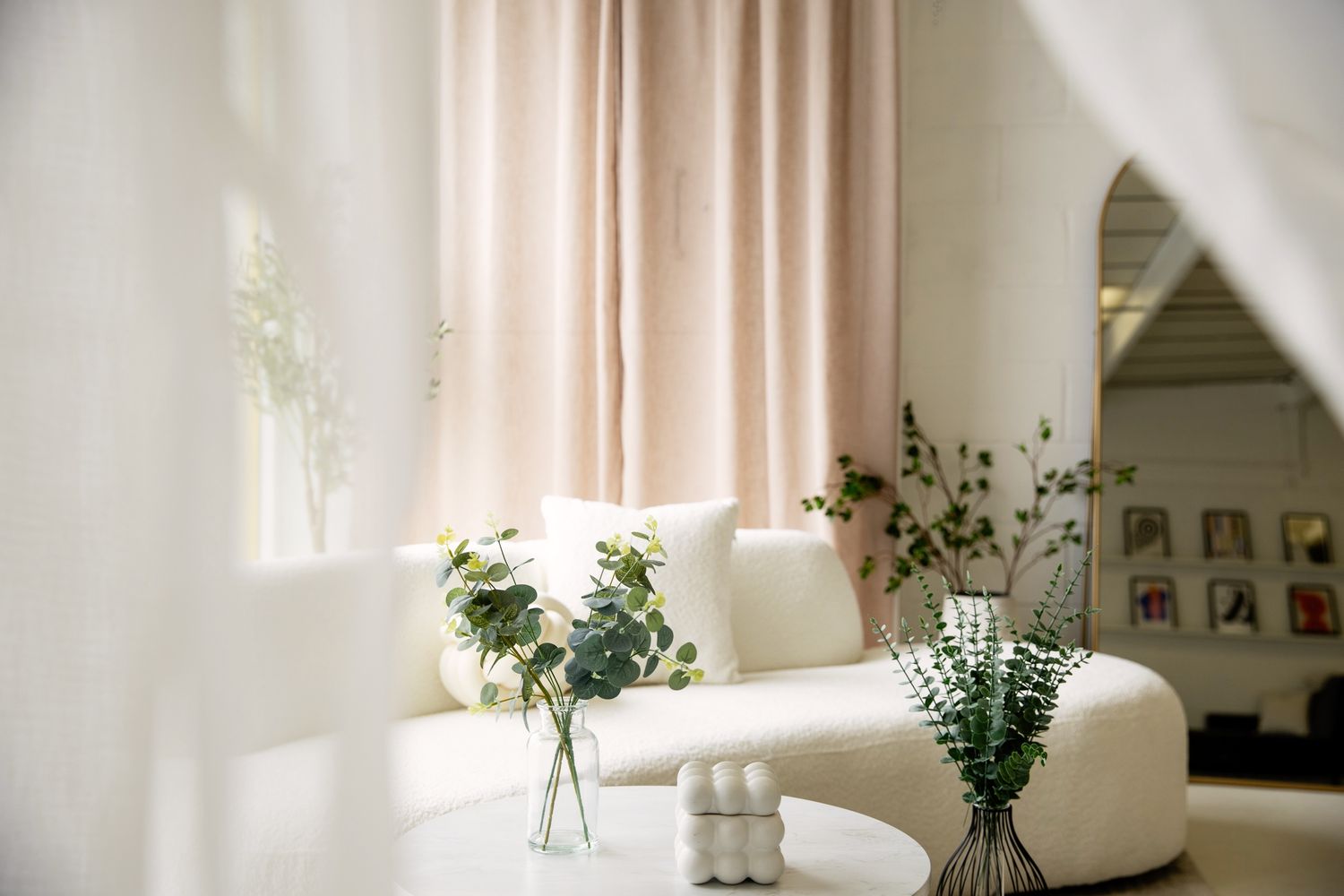 Bright interior spaces with white walls, natural light, and delicate floral arrangements.