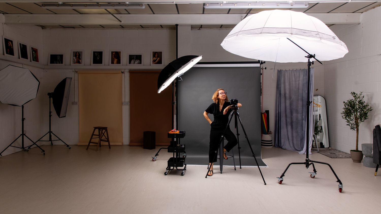 Professional photography studio setup with lighting equipment and backdrop.