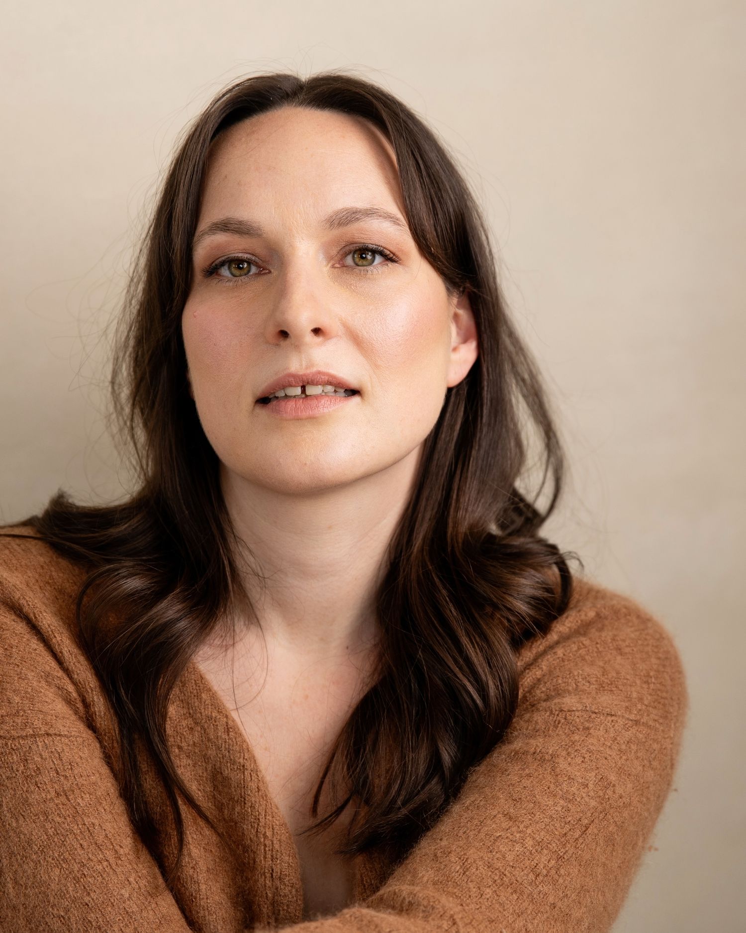 Artistic headshots featuring brown sweater and natural makeup.