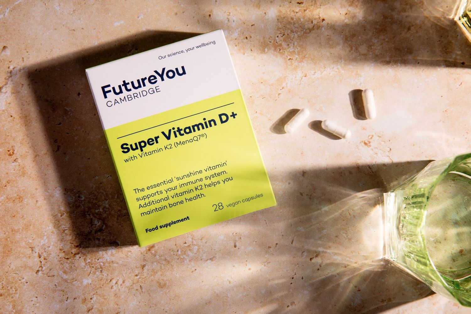 Health supplement product packaging displayed in sunlit setting.