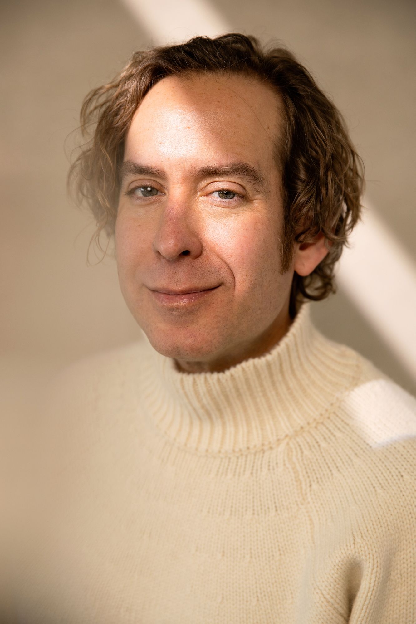 Portrait sequence showing warm lighting and cream turtleneck sweater.