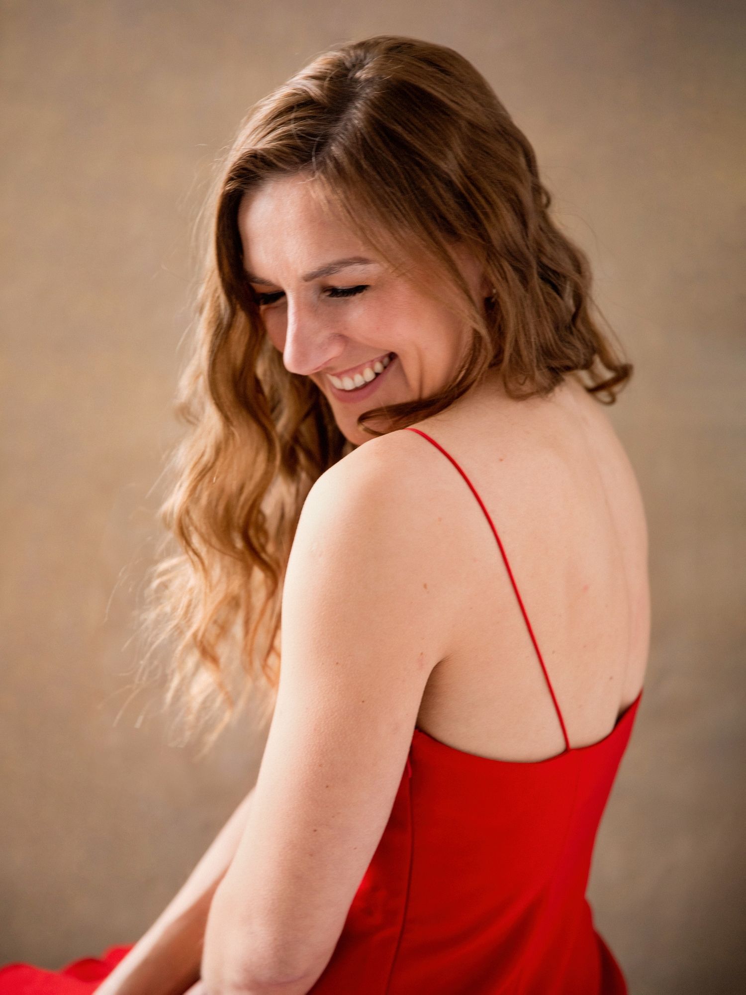 Dynamic portrait sequence showing movement in a red dress.
