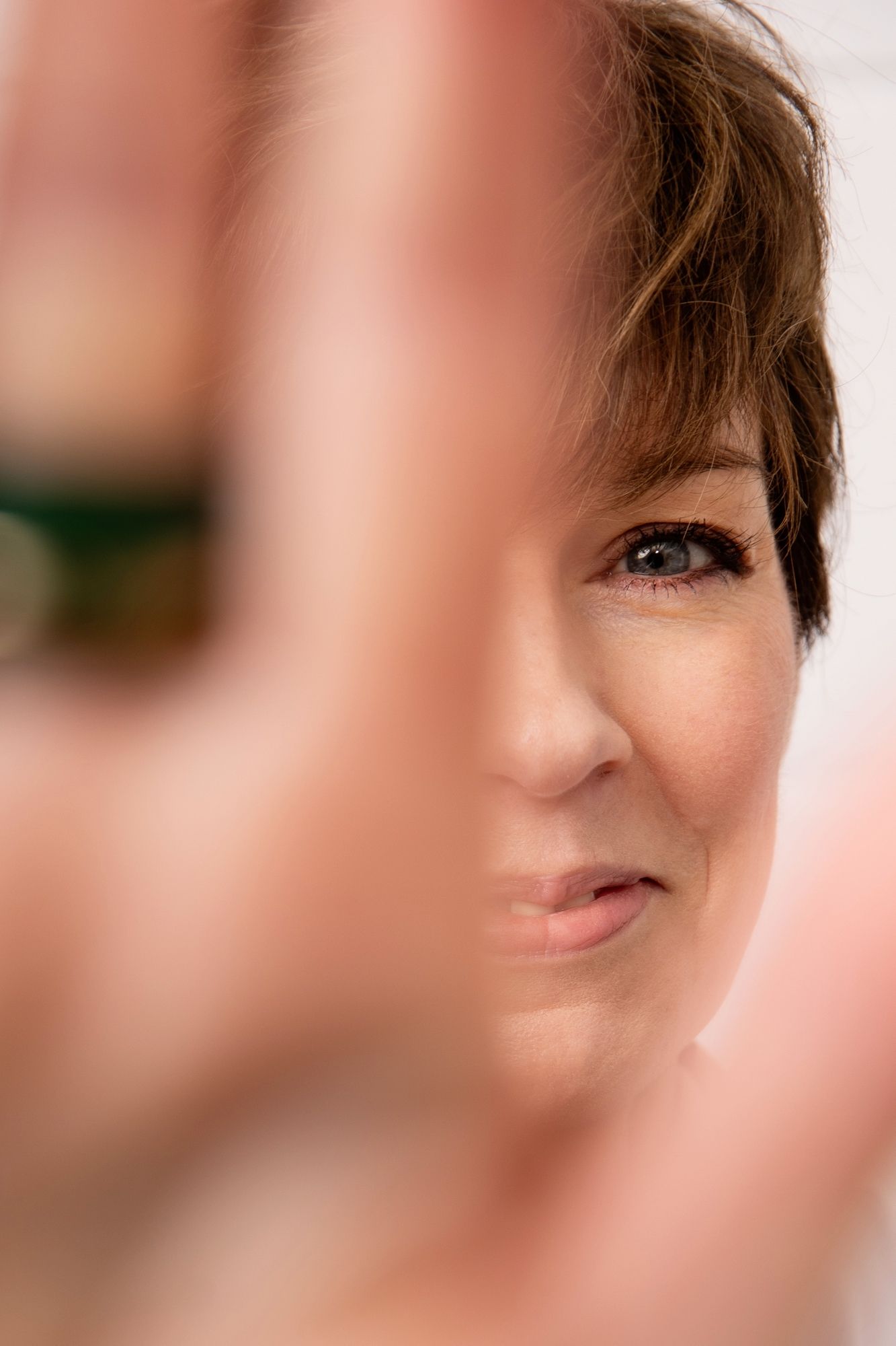 Extreme close-up portrait showing partial facial features in soft lighting.