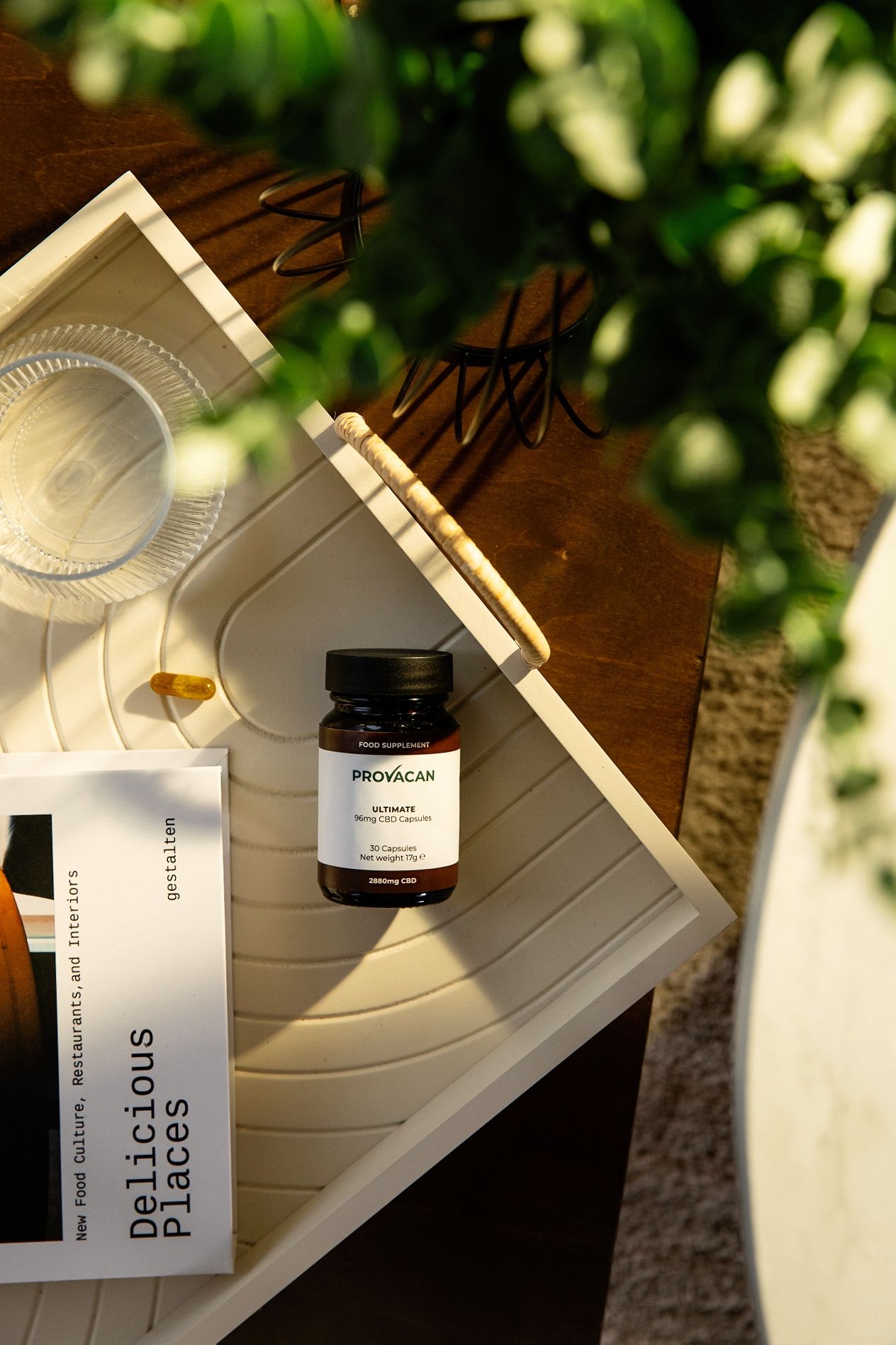 Vitamin supplement bottles and packaging arranged on wooden surface with natural lighting.