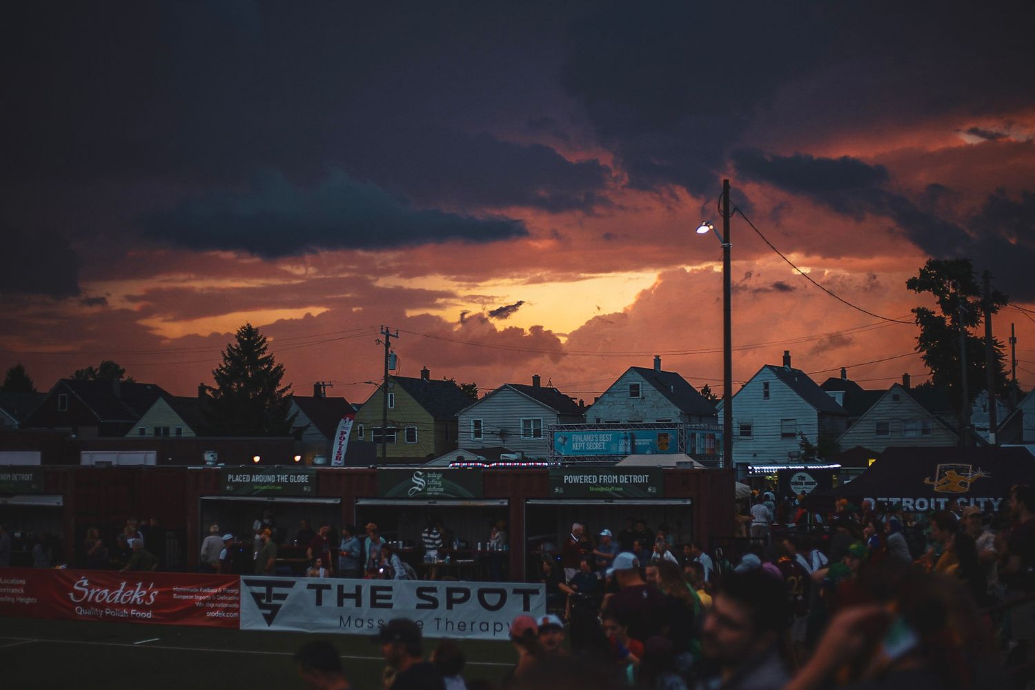 Dramatic sunset with dark storm clouds over a small stadium with 