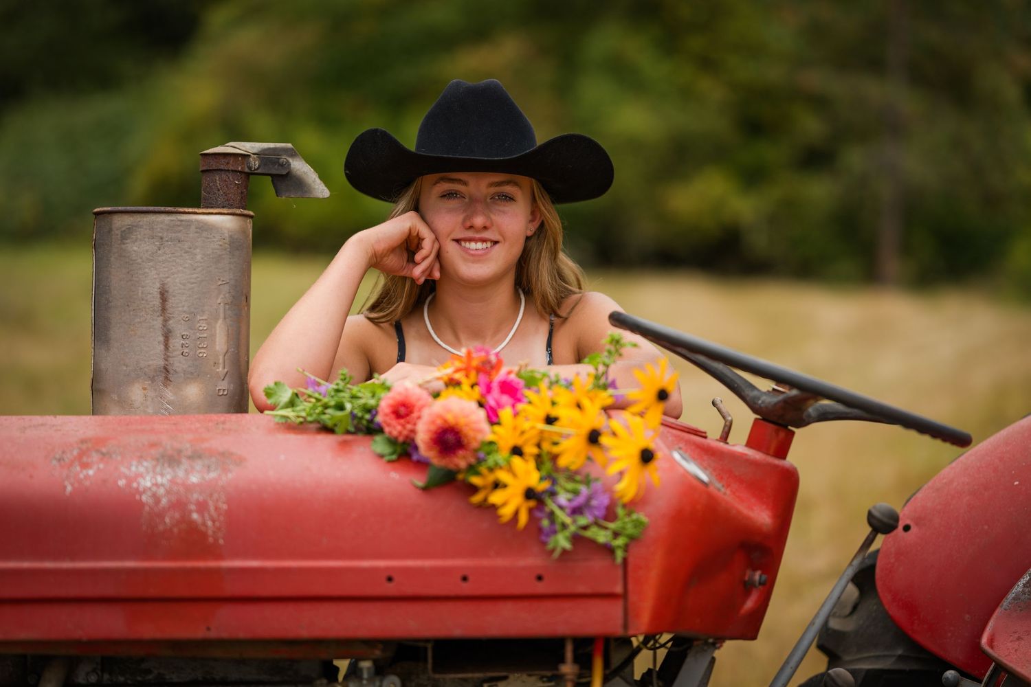 Senior photo with Hannah and grandpa's tractor