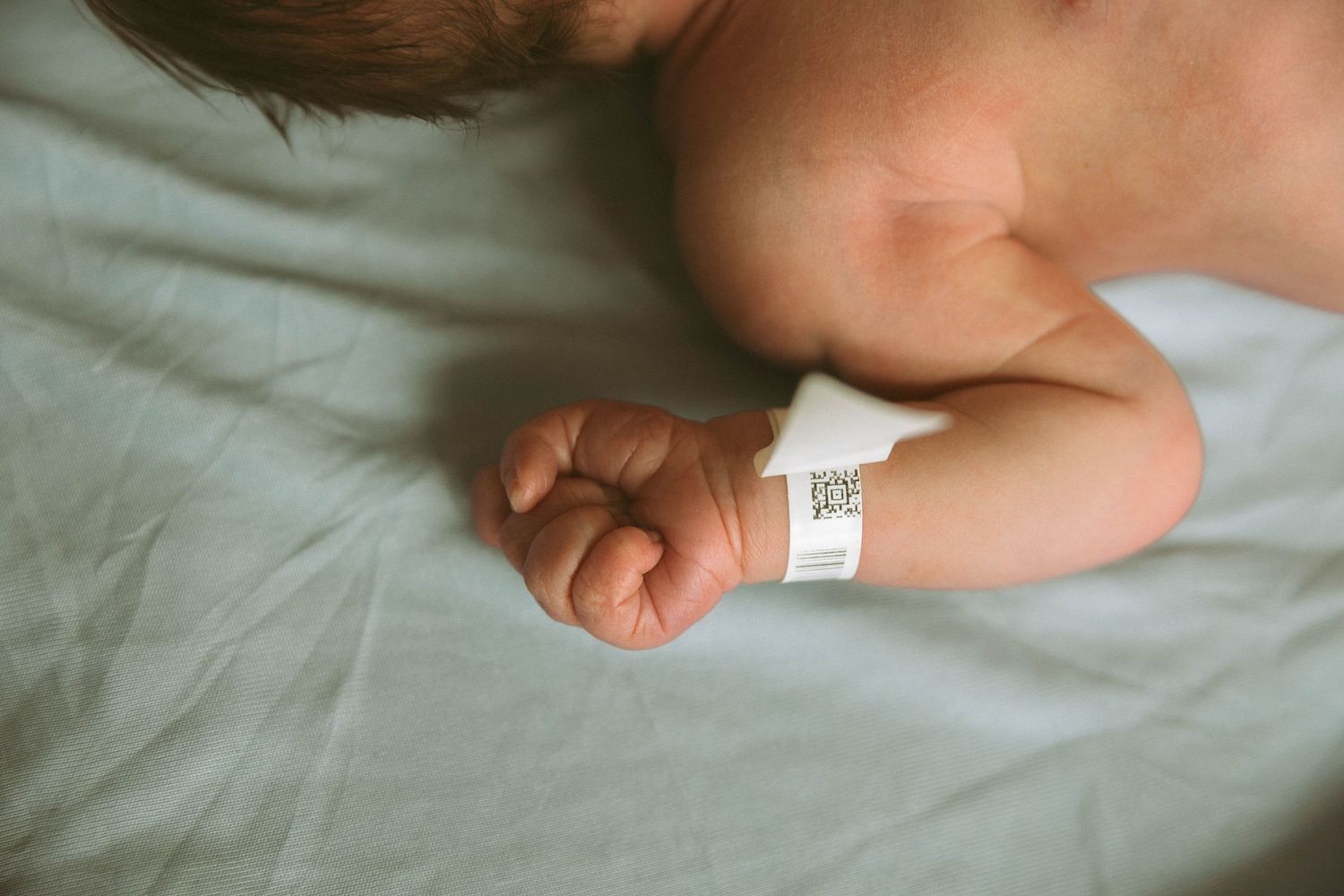 Toronto Fresh 48 newborn photography capturing mother and baby in hospital within first 24 hours after birth
