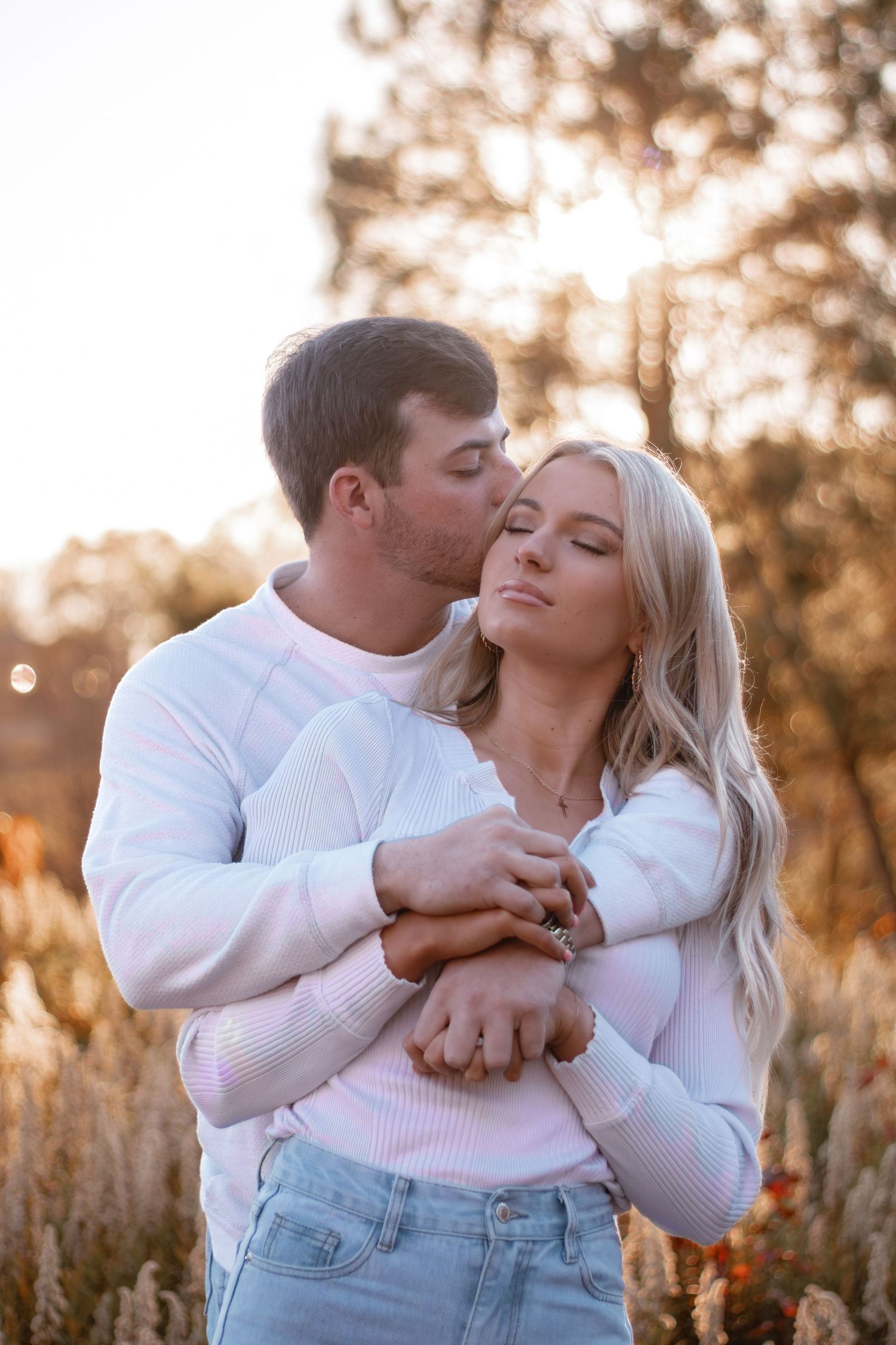 Romantic outdoor photo sequence showing tender moments between a couple in white sweaters.