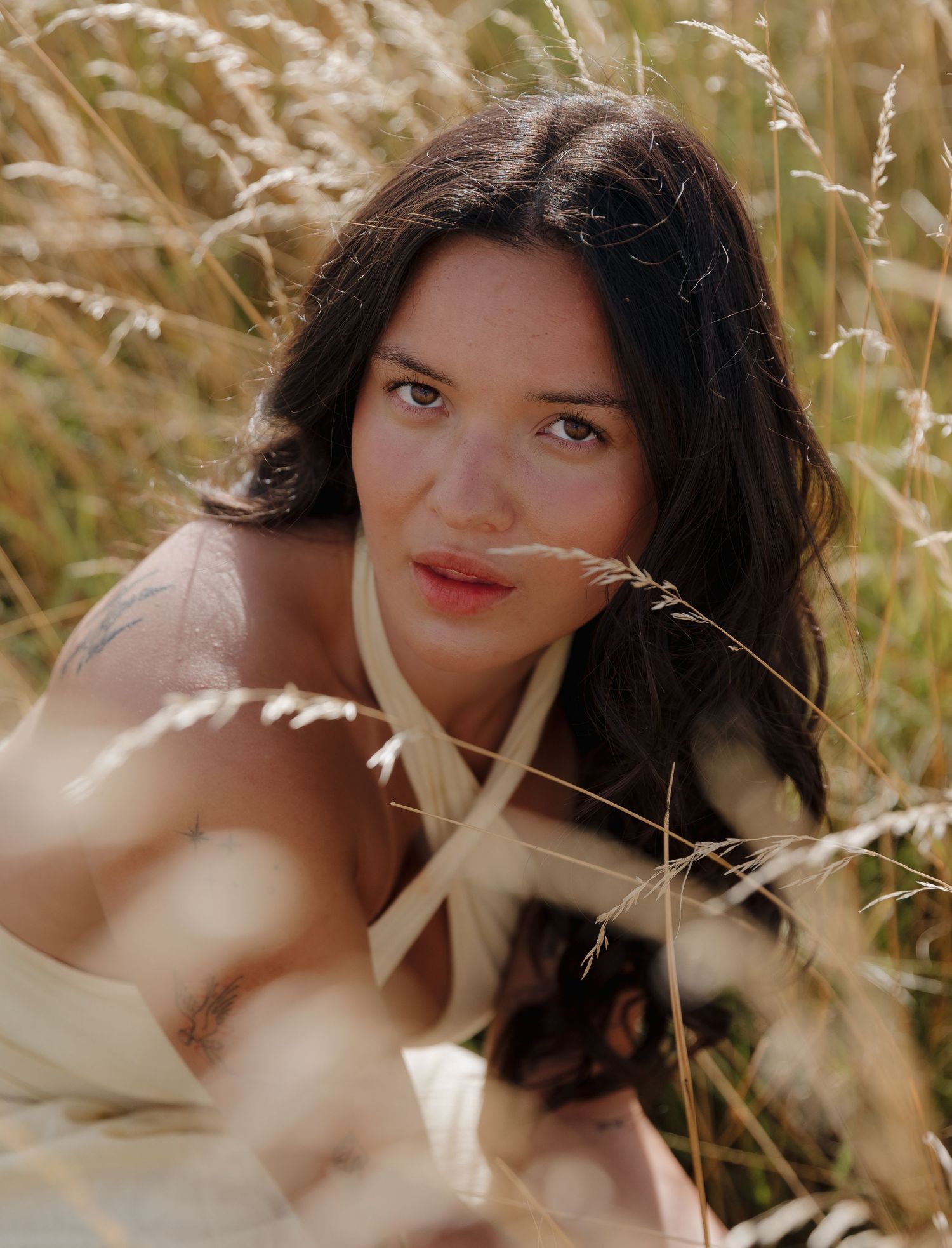 Artistic portrait taken in golden wheat field during sunset.