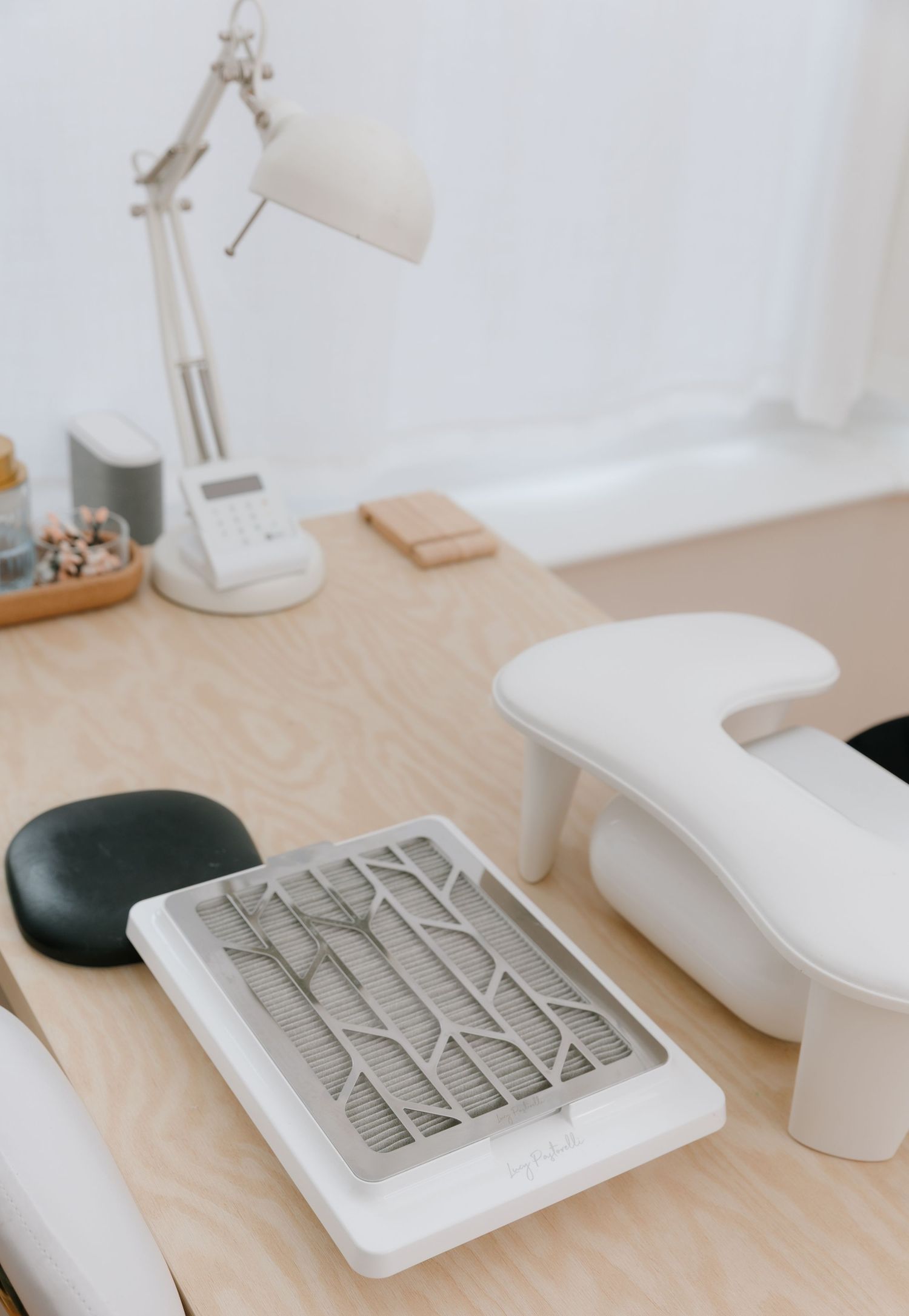 Minimalist white desk setup with keyboard and office accessories.