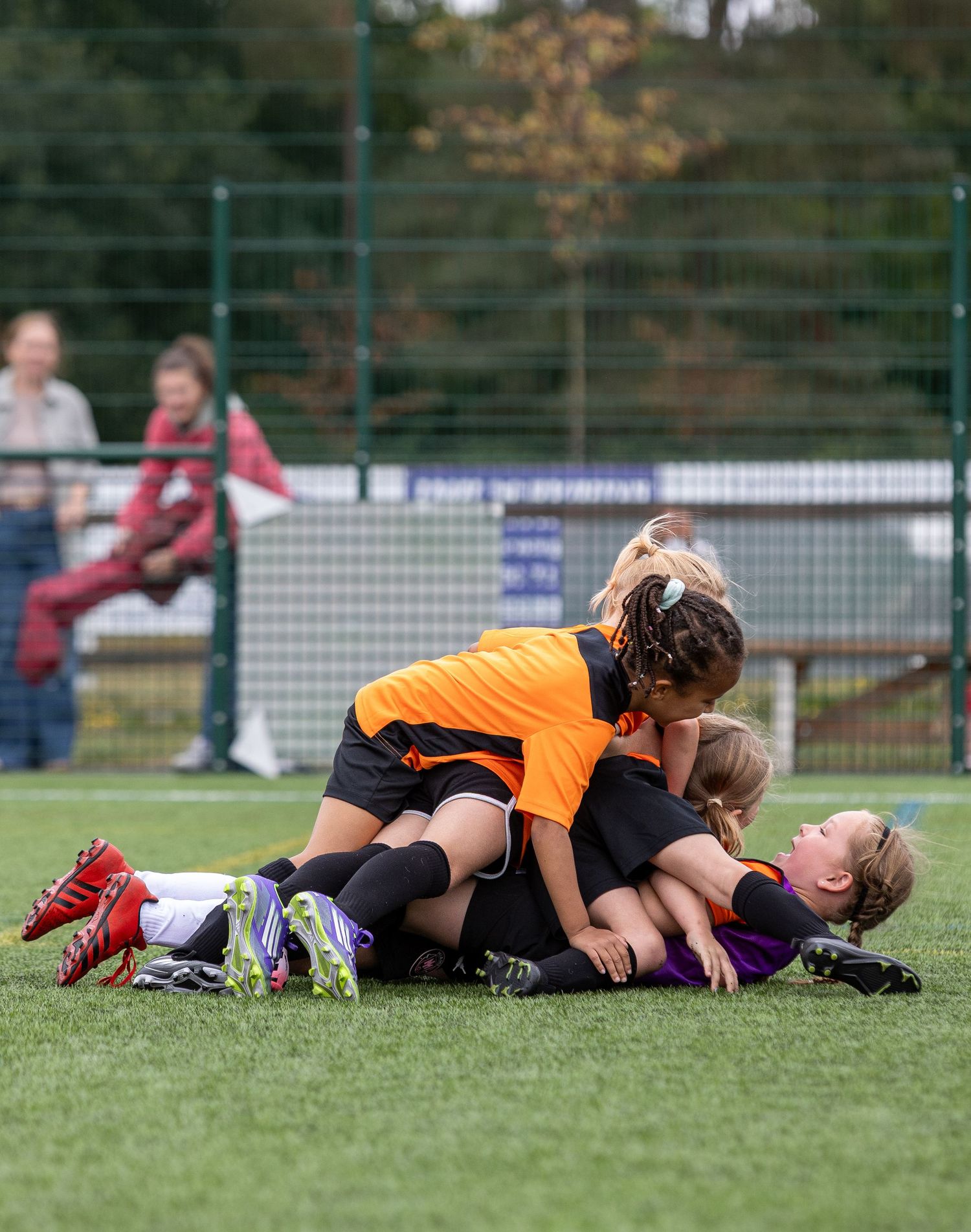 Players lie exhausted on a sports field after an intense match or training session.