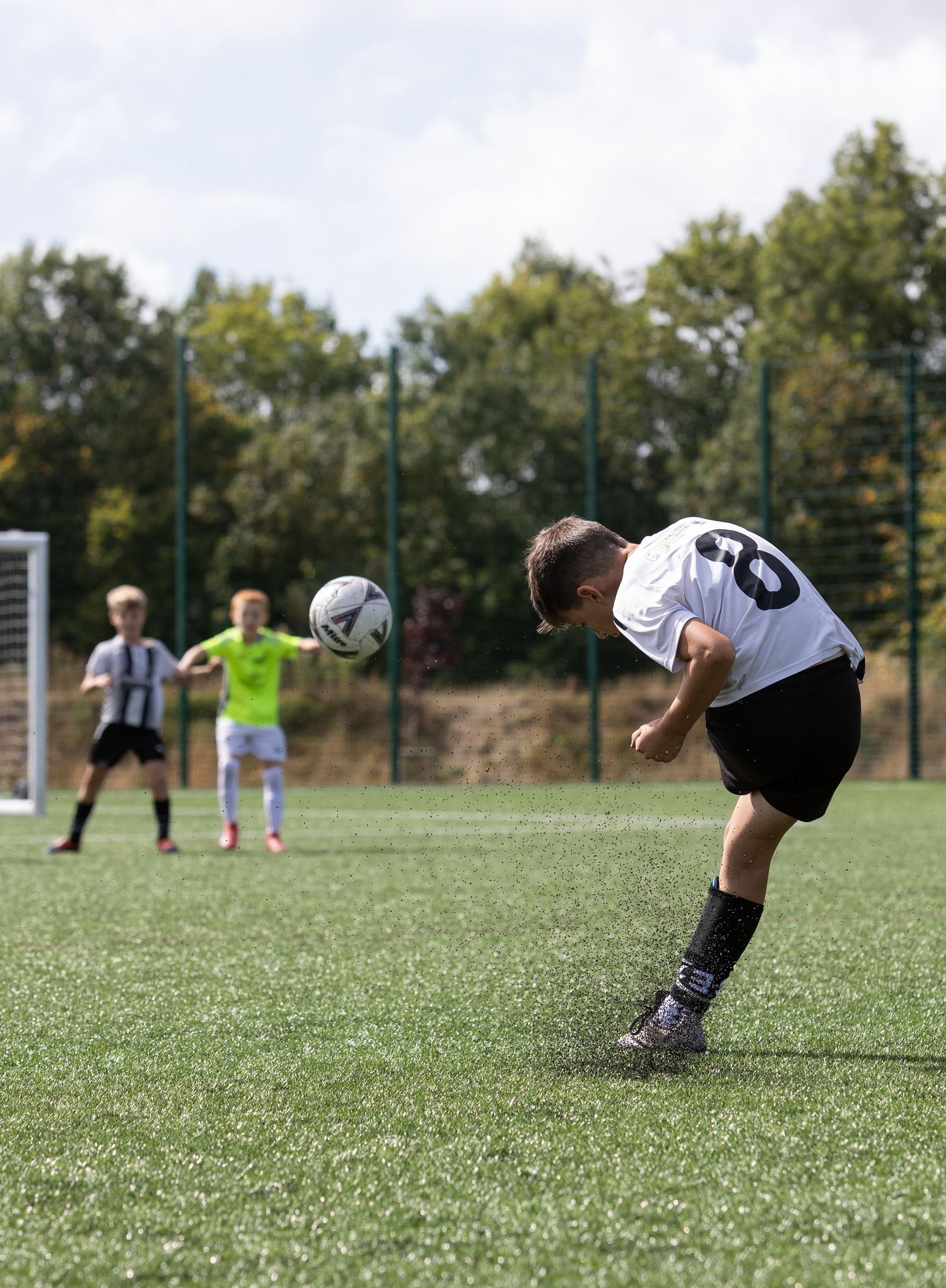 A sequence of soccer goalkeeper diving saves shown in multiple action frames on a grass field.