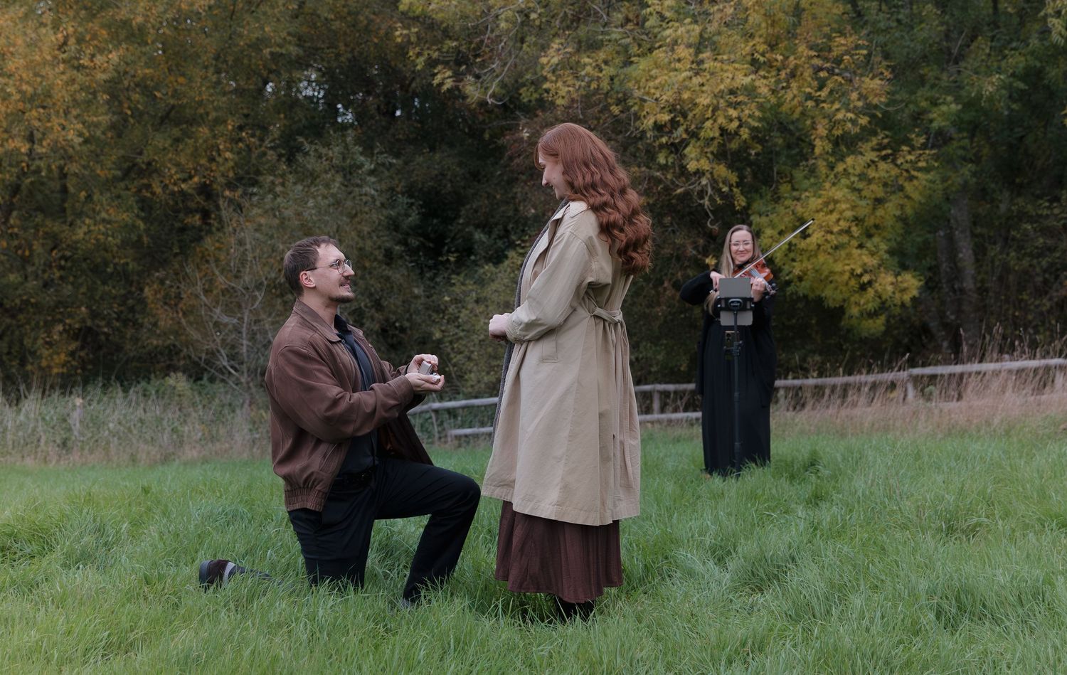 A romantic outdoor proposal sequence showing a couple in a grassy field during autumn.