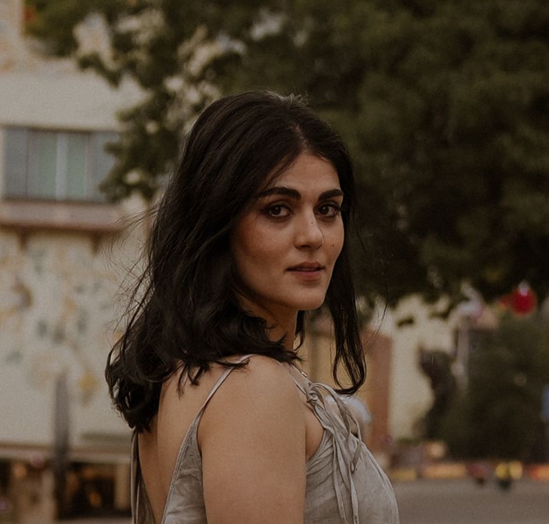 Atmospheric portrait session in warm evening light with urban background.