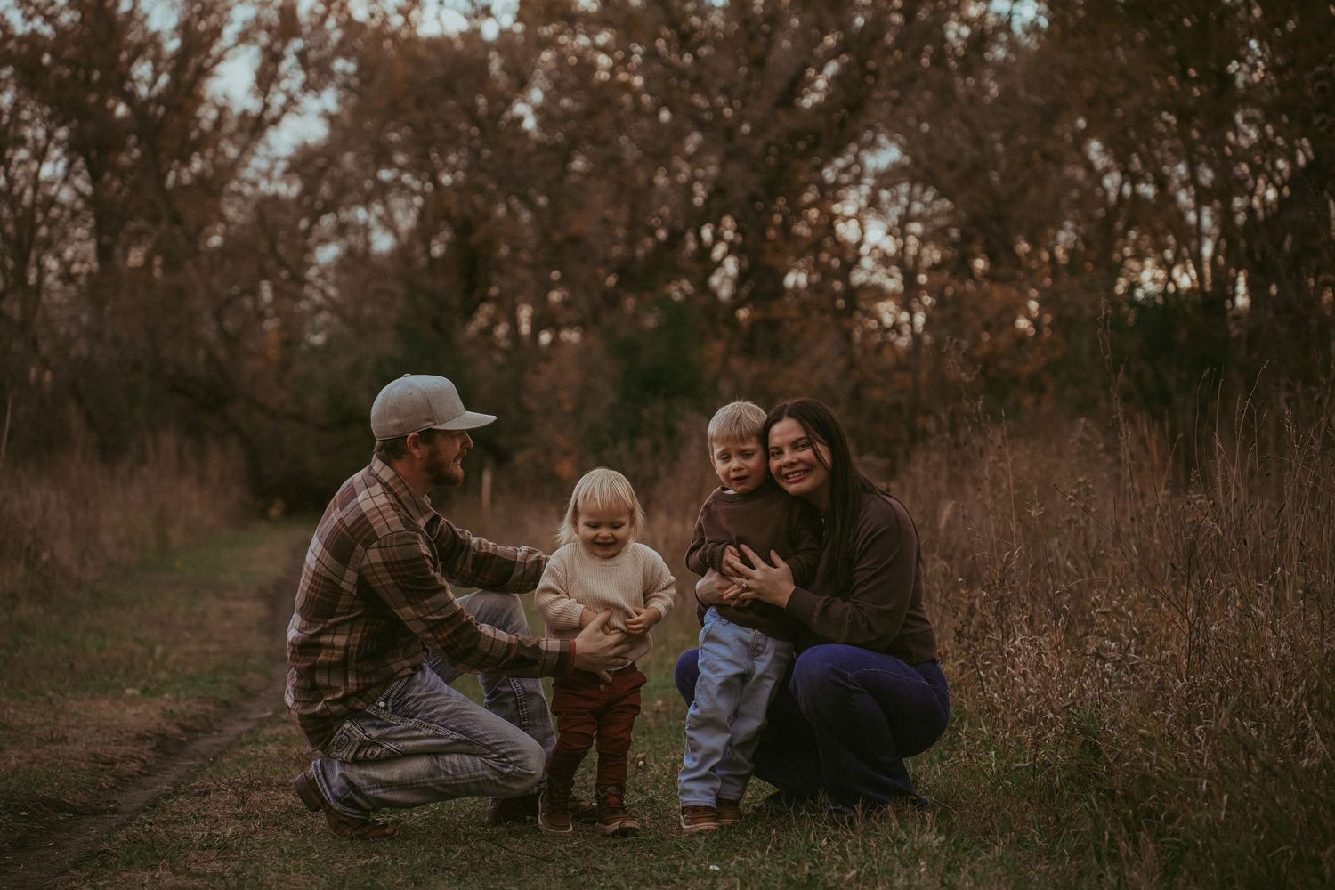 A family spends time together on a nature trail during sunset.