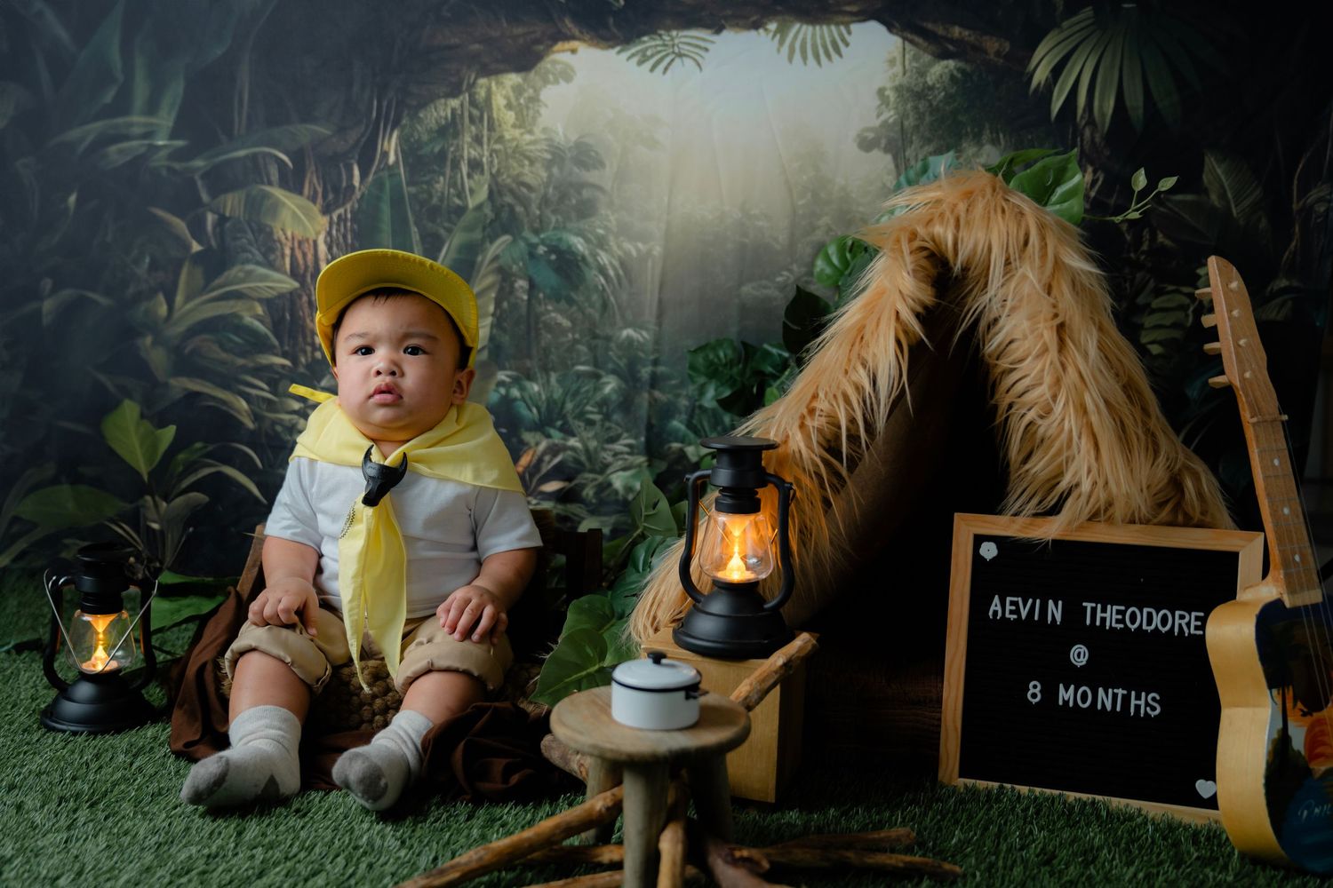 Woodland forest themed photo setup with lanterns and camping accessories.