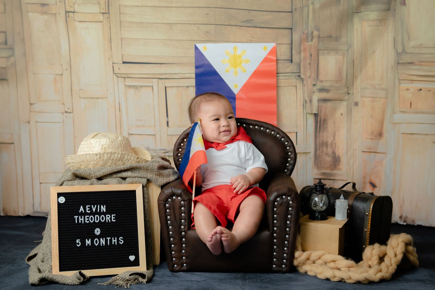 Vintage-style photo setup with Filipino flag, classic leather chair, and traditional decorative elements.