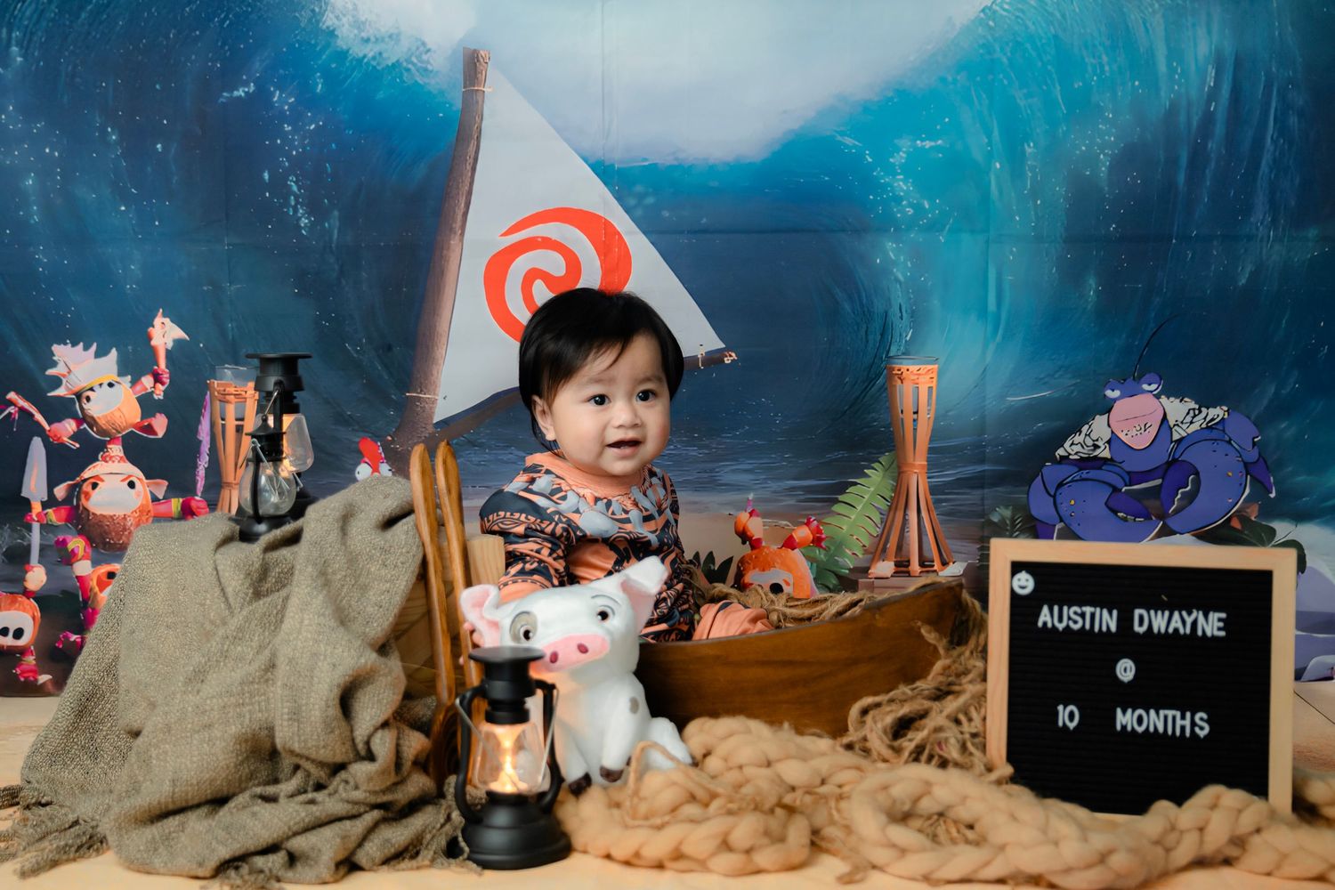 Moana inspired beach themed photography set with ocean backdrop and tropical decorations.